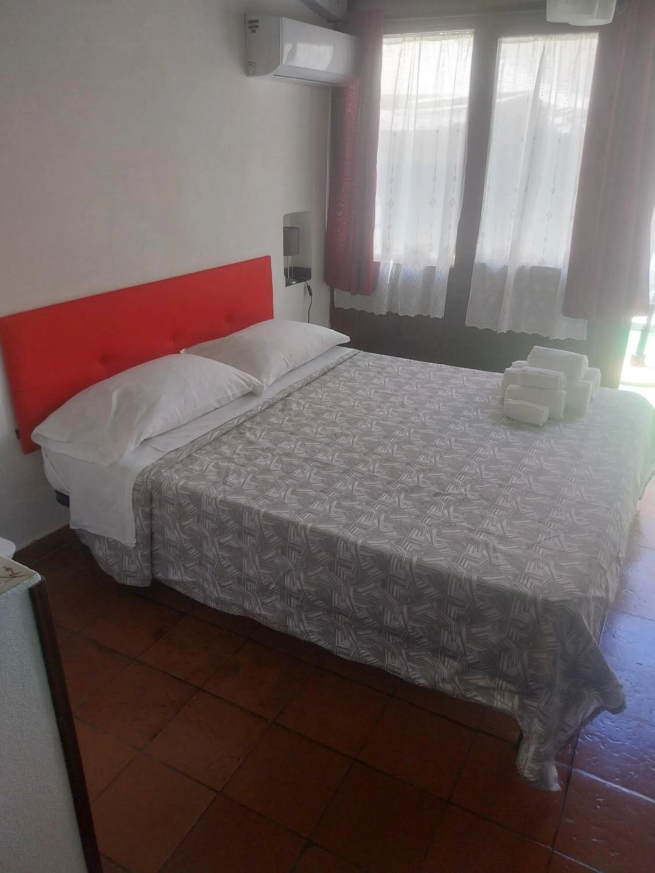 Bed in Le Rocce Holiday Rooms