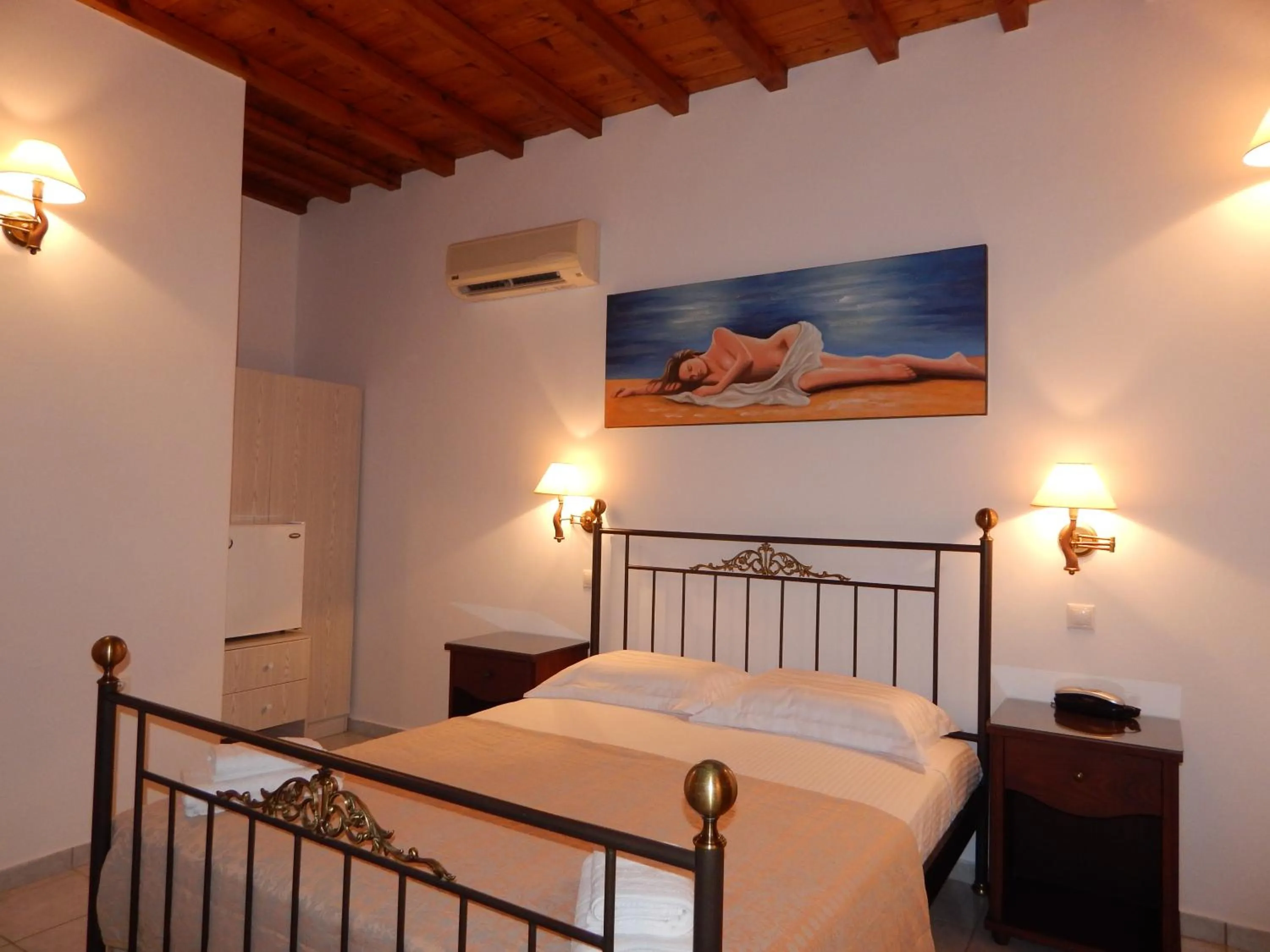 Bed in Tinos Suites & Apartments