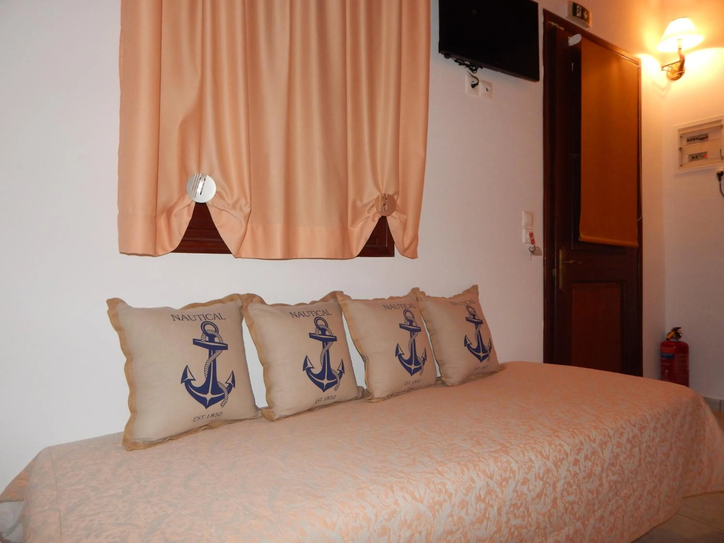 Bed in Tinos Suites & Apartments