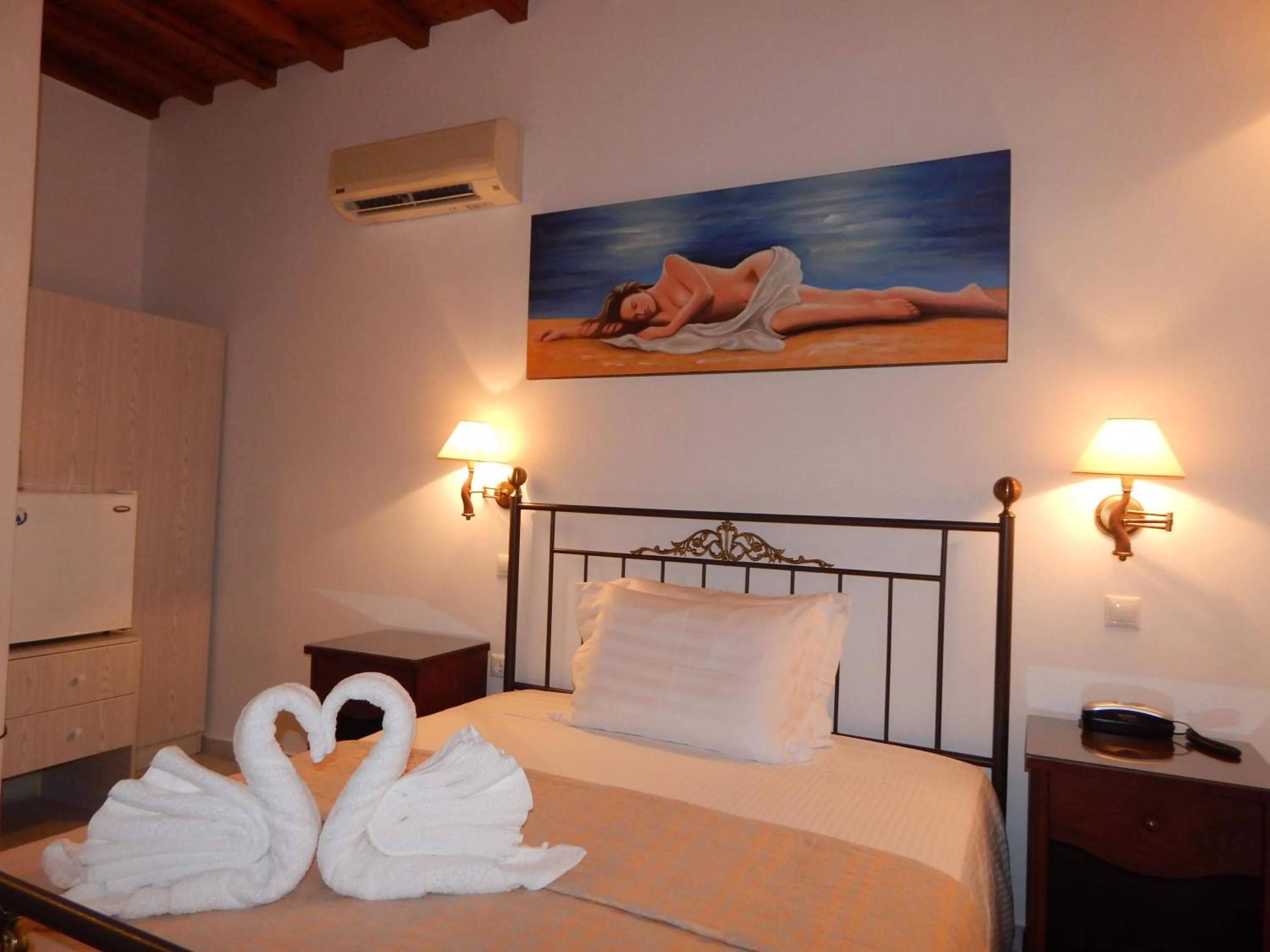 Bed in Tinos Suites & Apartments