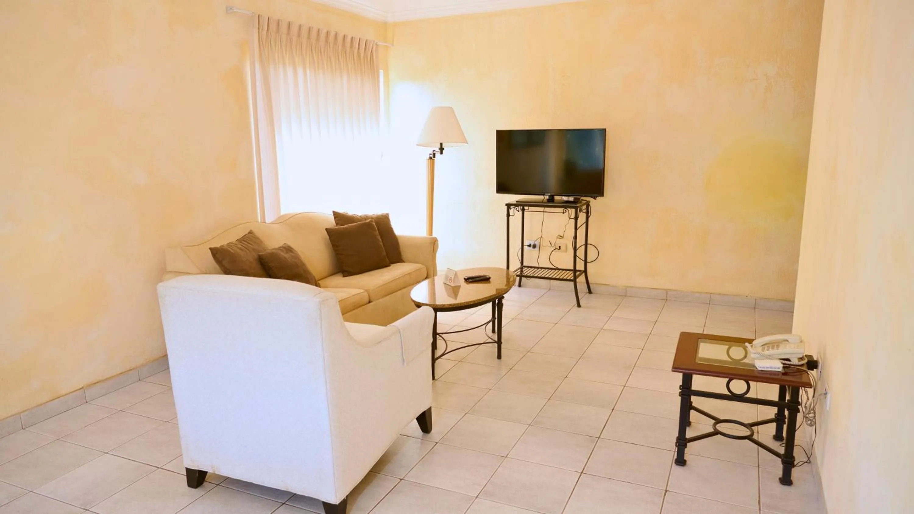 Communal lounge/ TV room in Buganvillas Hotel Suites