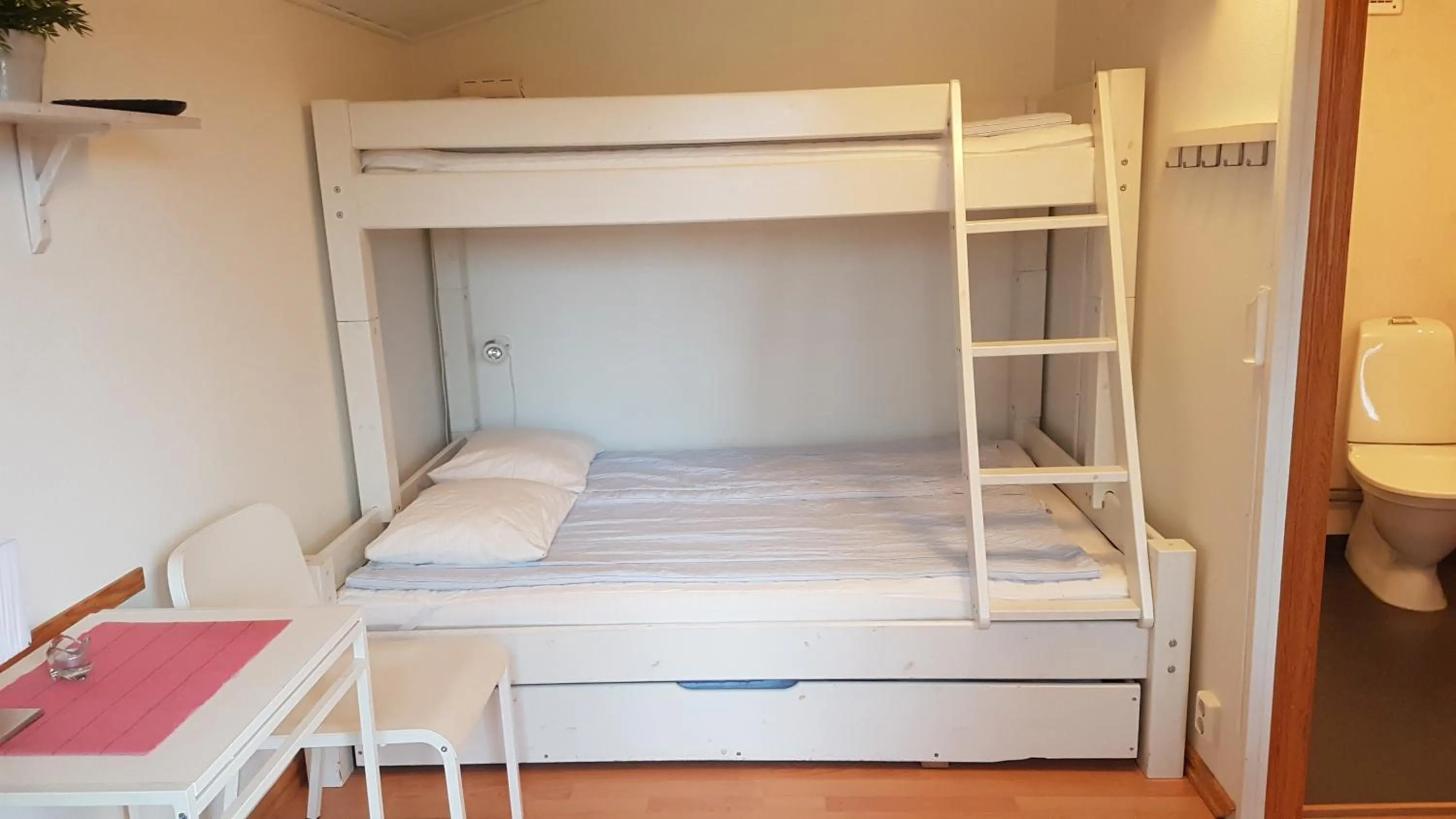 Photo of the whole room, Bed in Korskullens Stugor