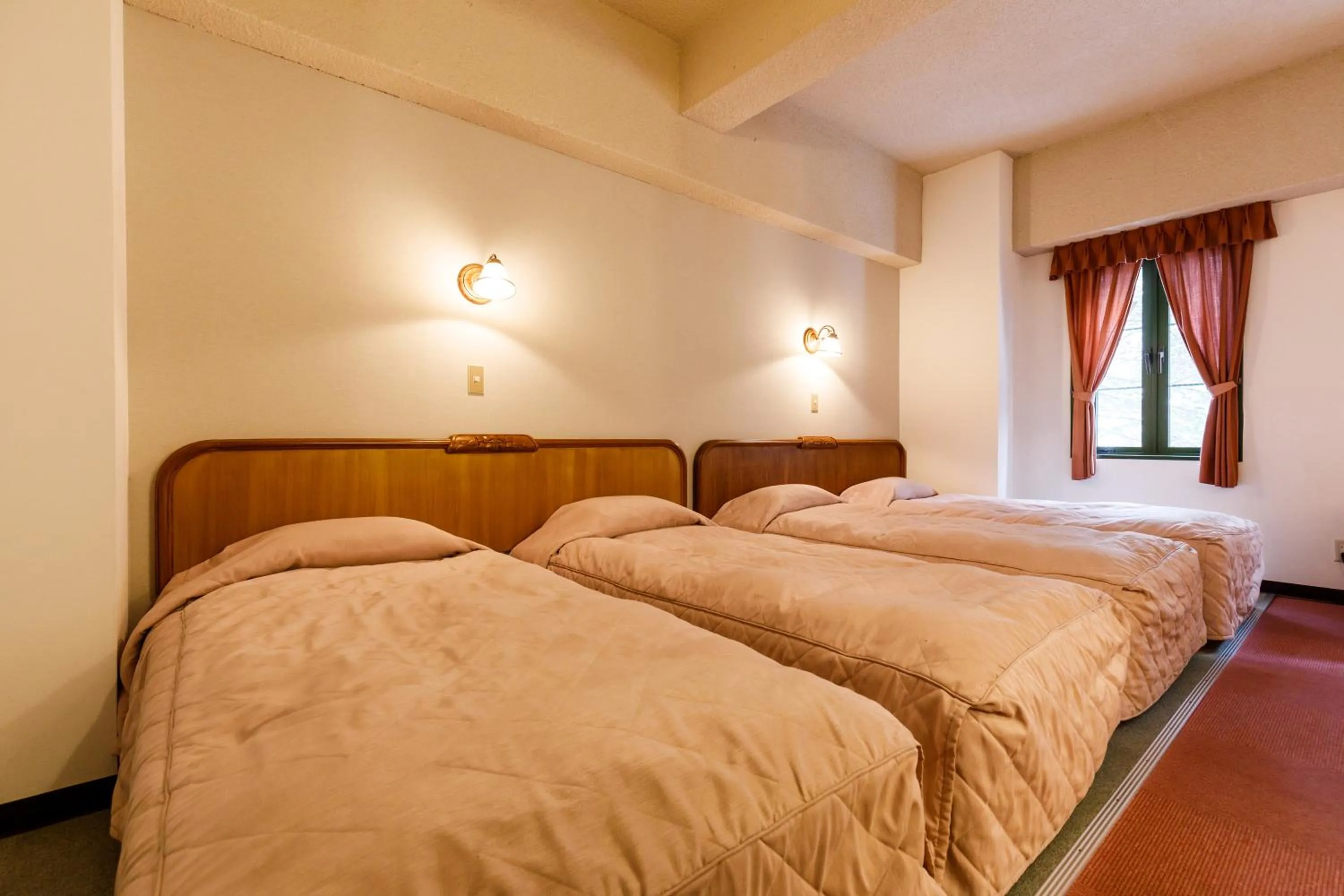 Bed in ホテルけやきの樹