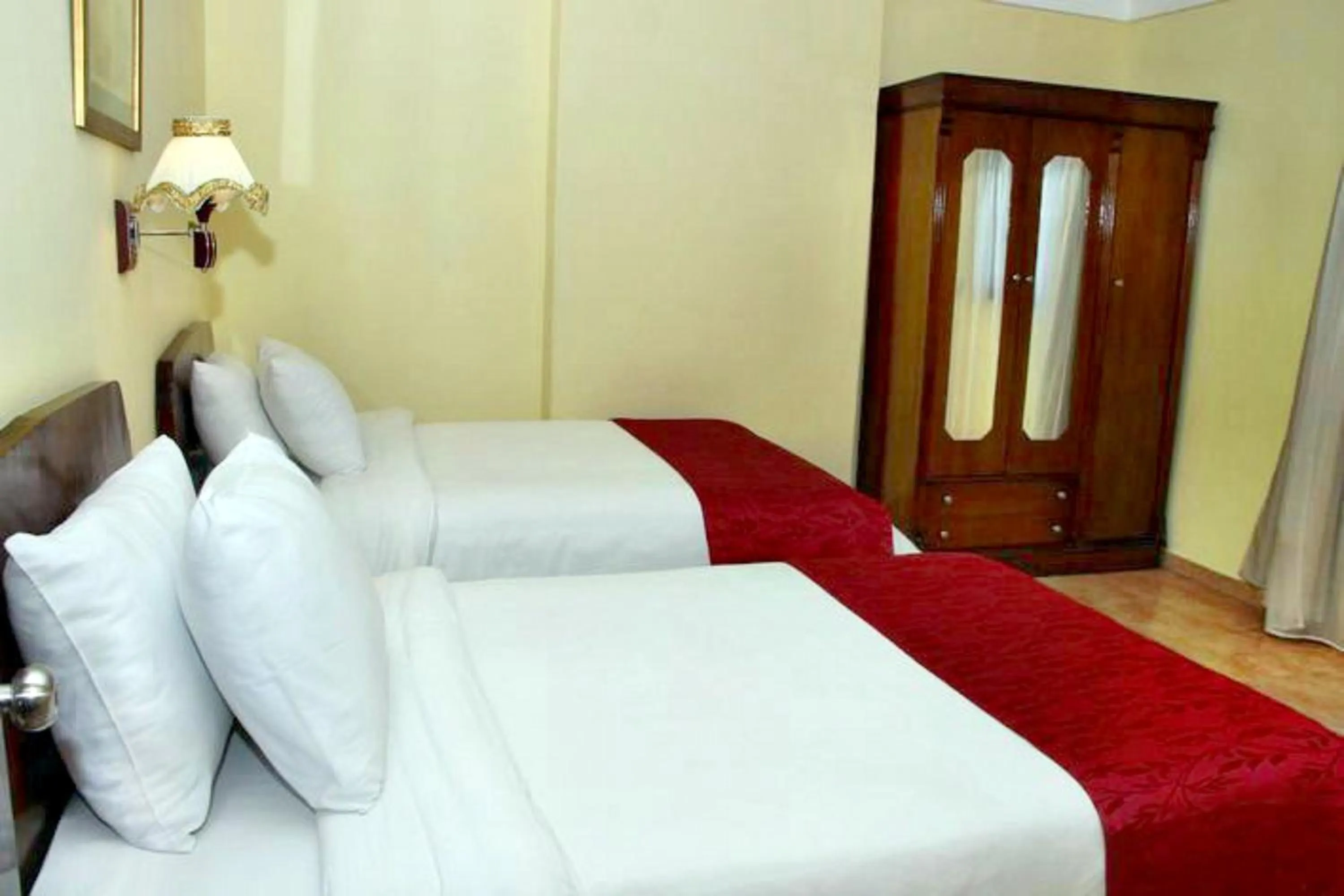 Bed in Alexandria Mediterranean Suites