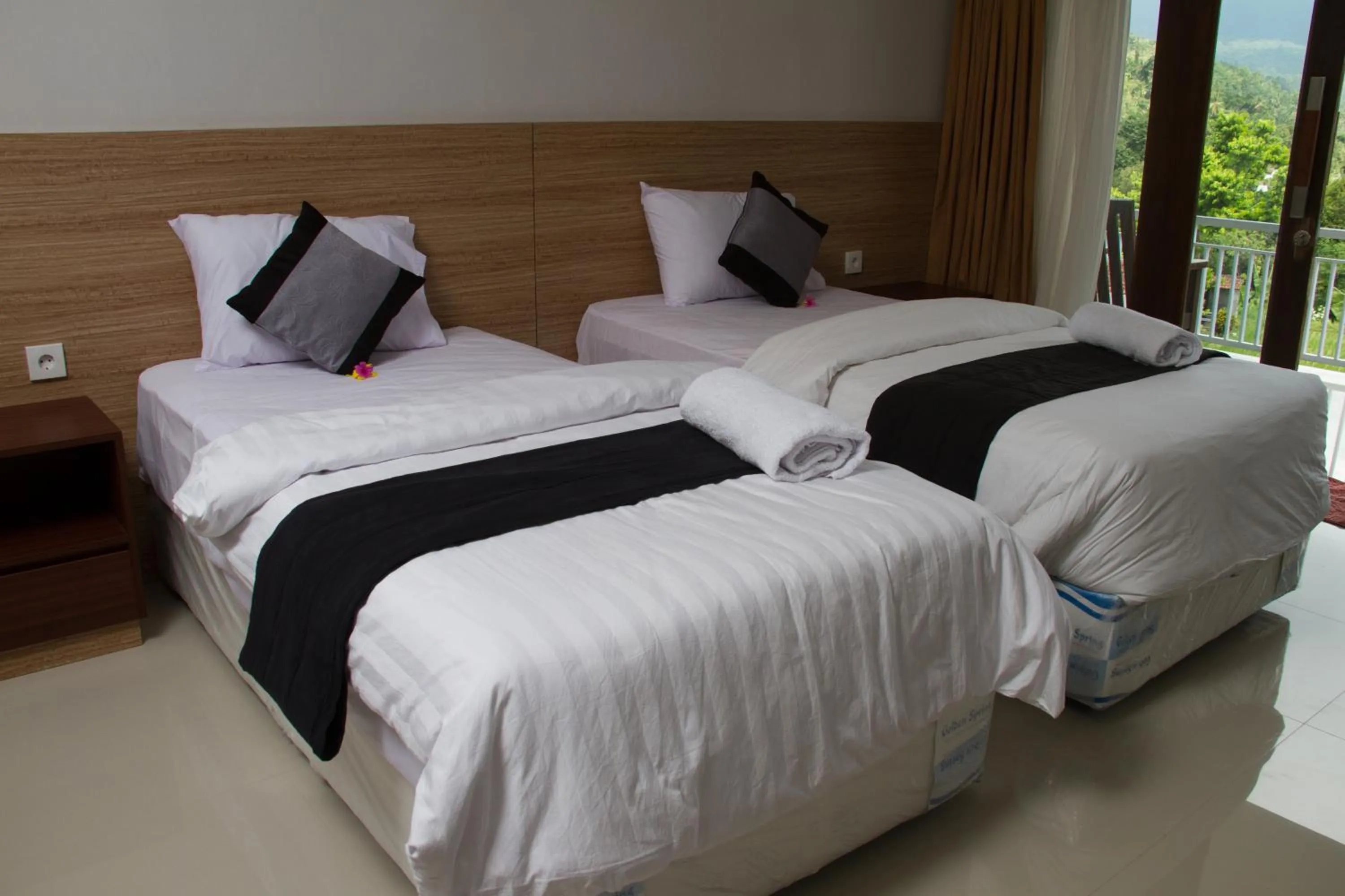 Bed in Mandhasativa Homestay