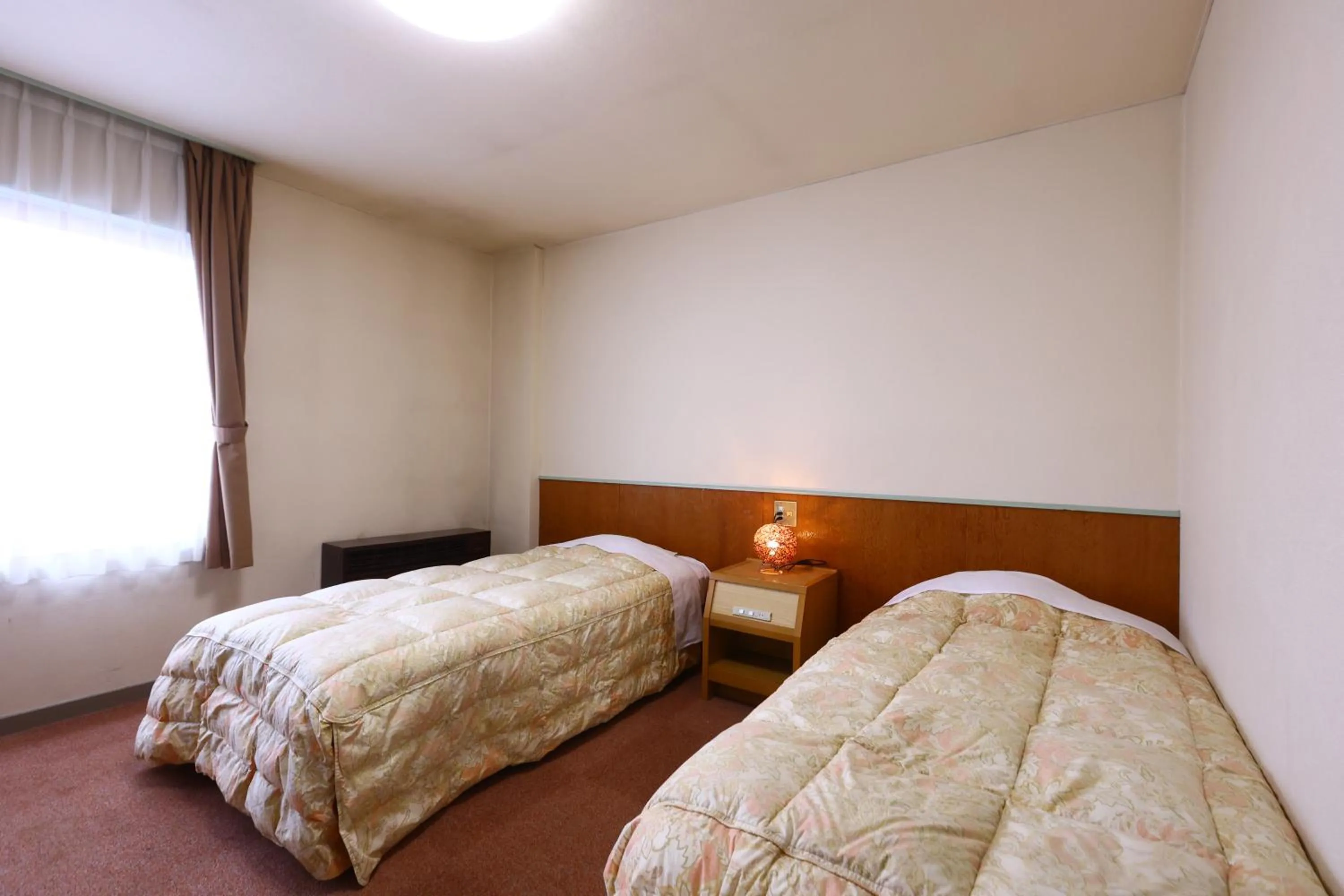 Bed in Hotel Sunplaza Tsugaike