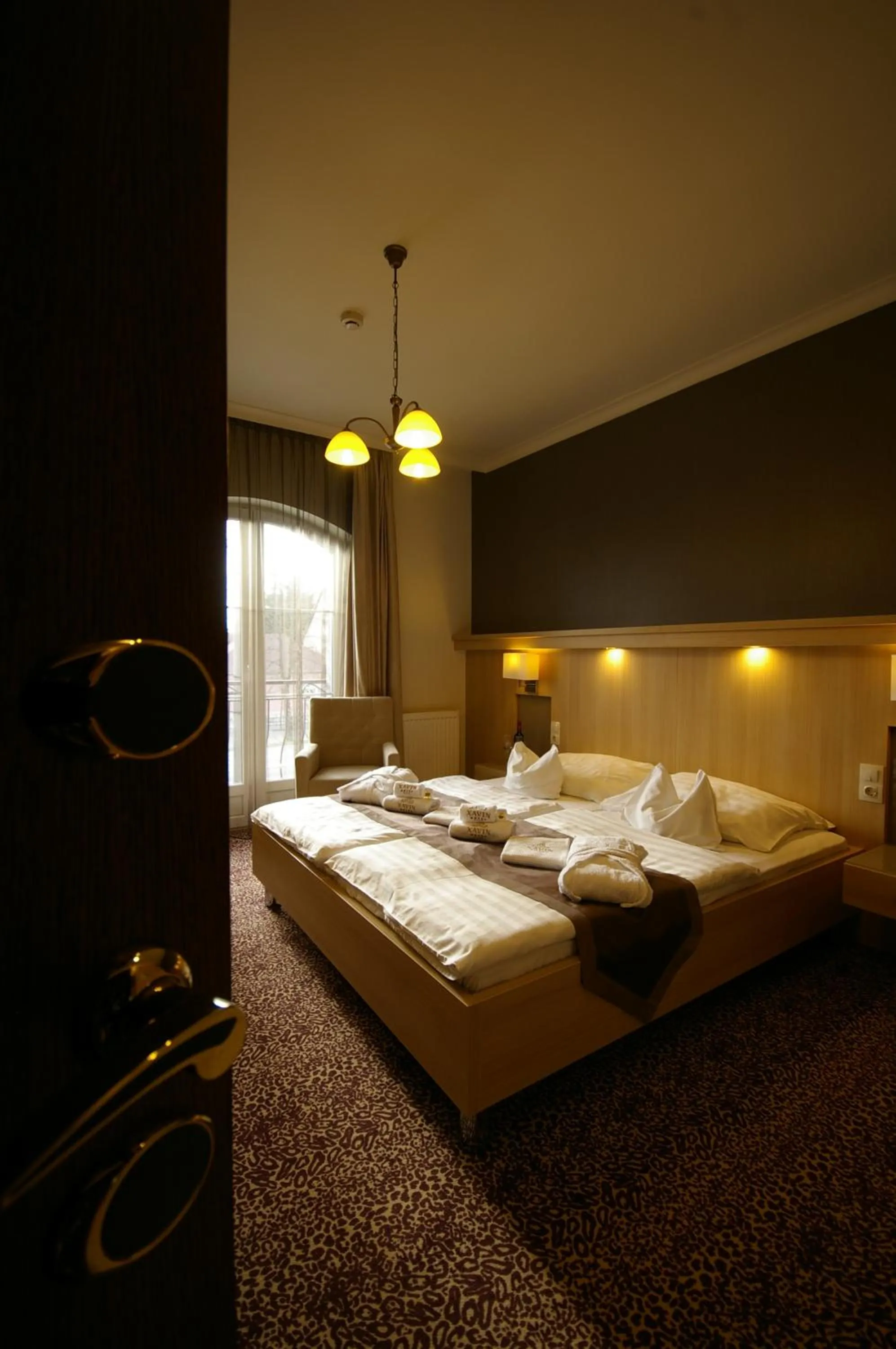 Bed in Xavin Wellness Hotel & Restaurant