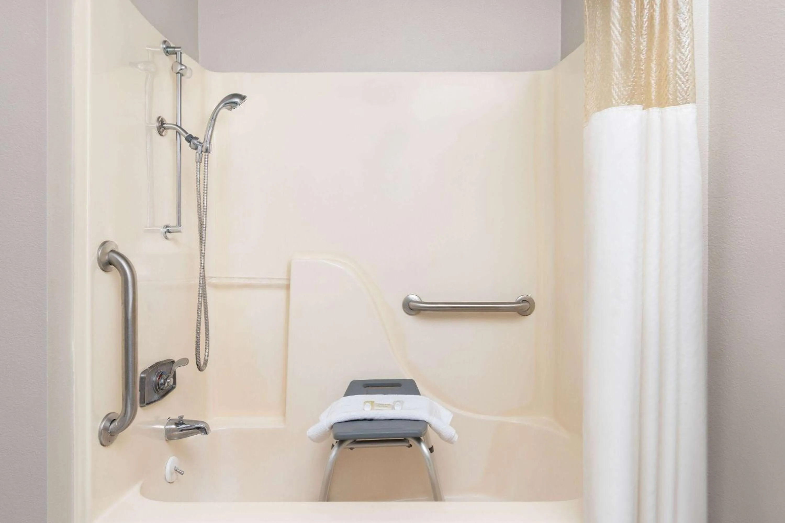 Bathroom in Days Inn & Suites by Wyndham Kansas City - CHIEFS Stadium