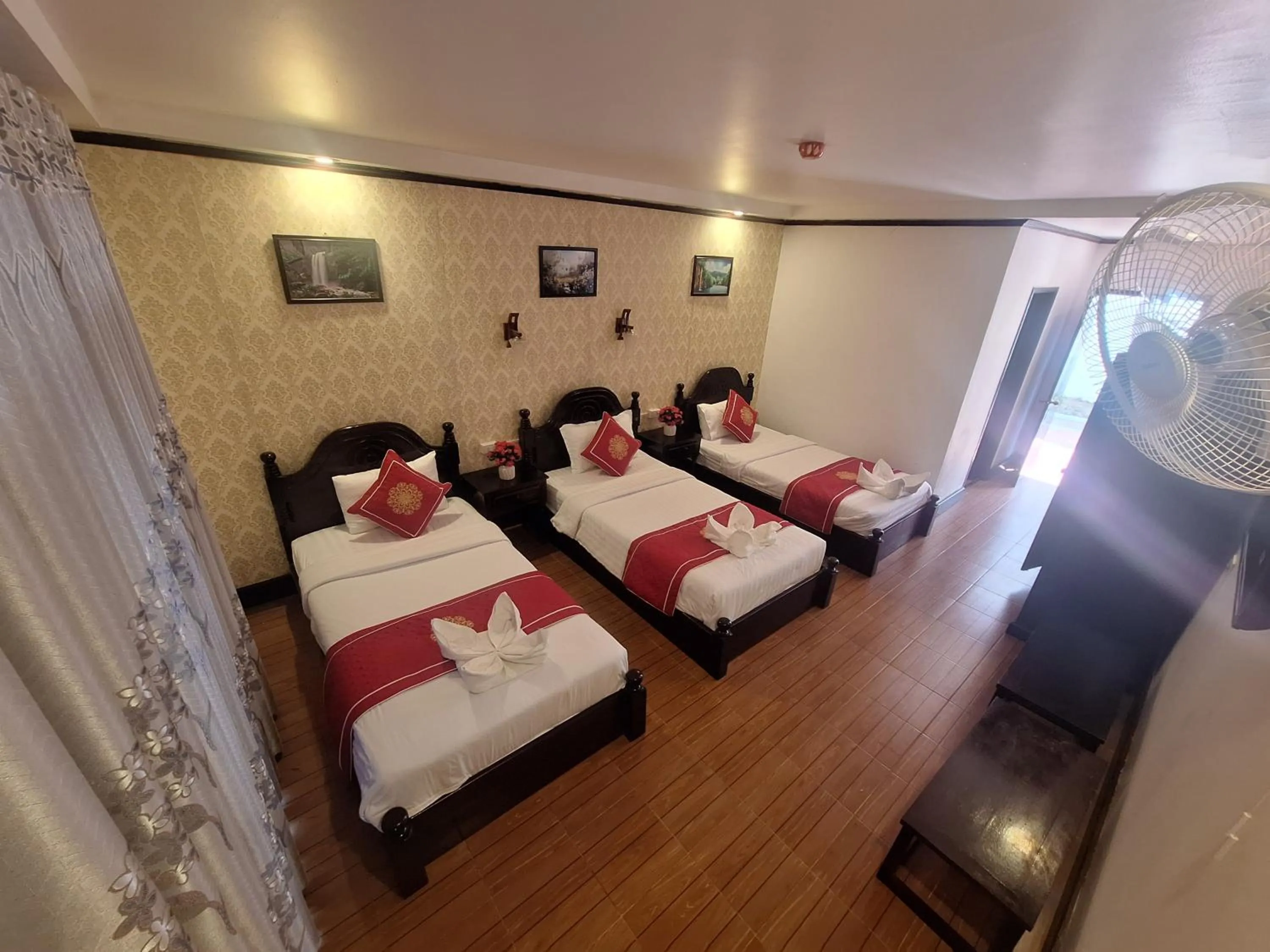 Bed in Luang Prabang Pavilion Hotel & Travel