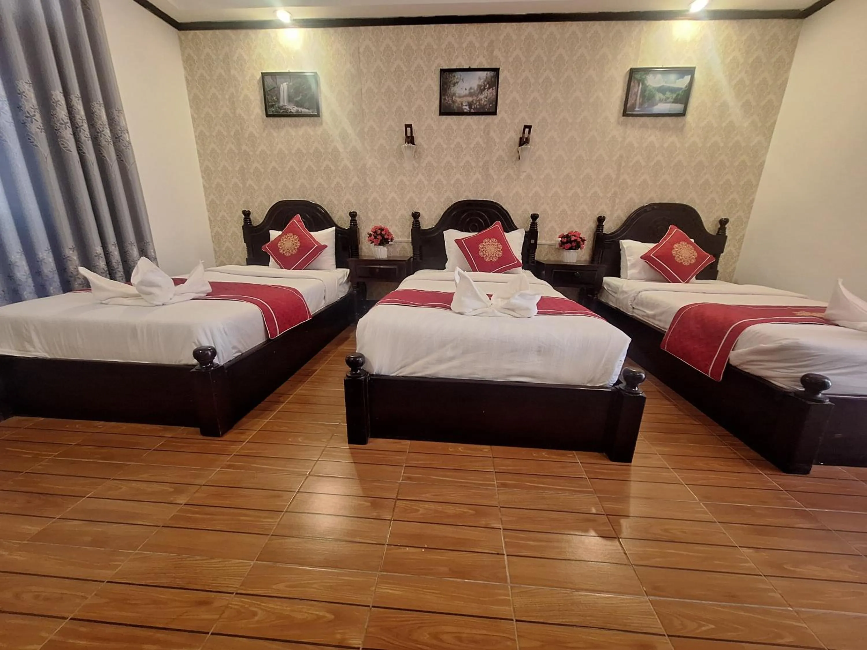 Bed in Luang Prabang Pavilion Hotel & Travel