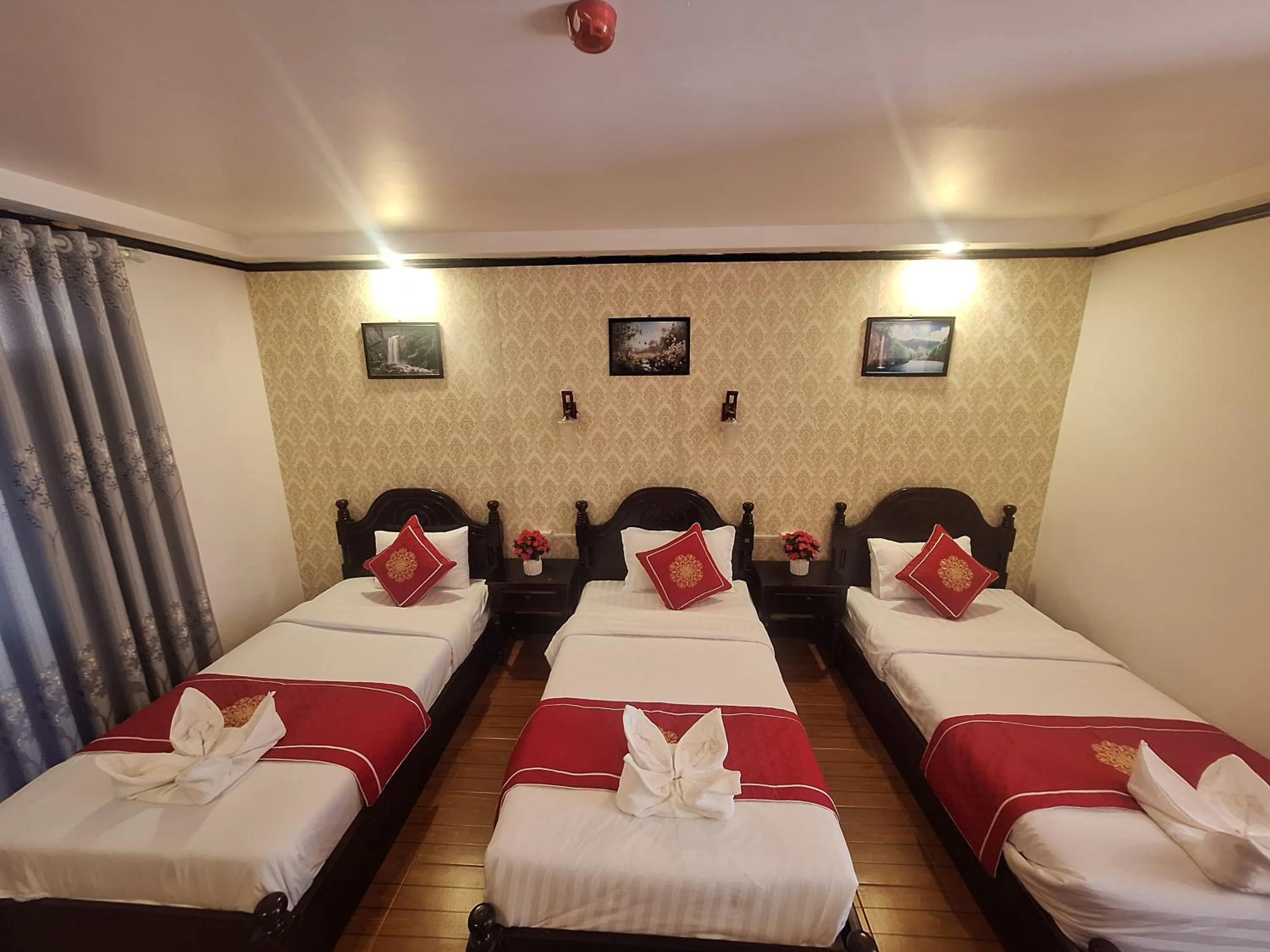 Bed in Luang Prabang Pavilion Hotel & Travel