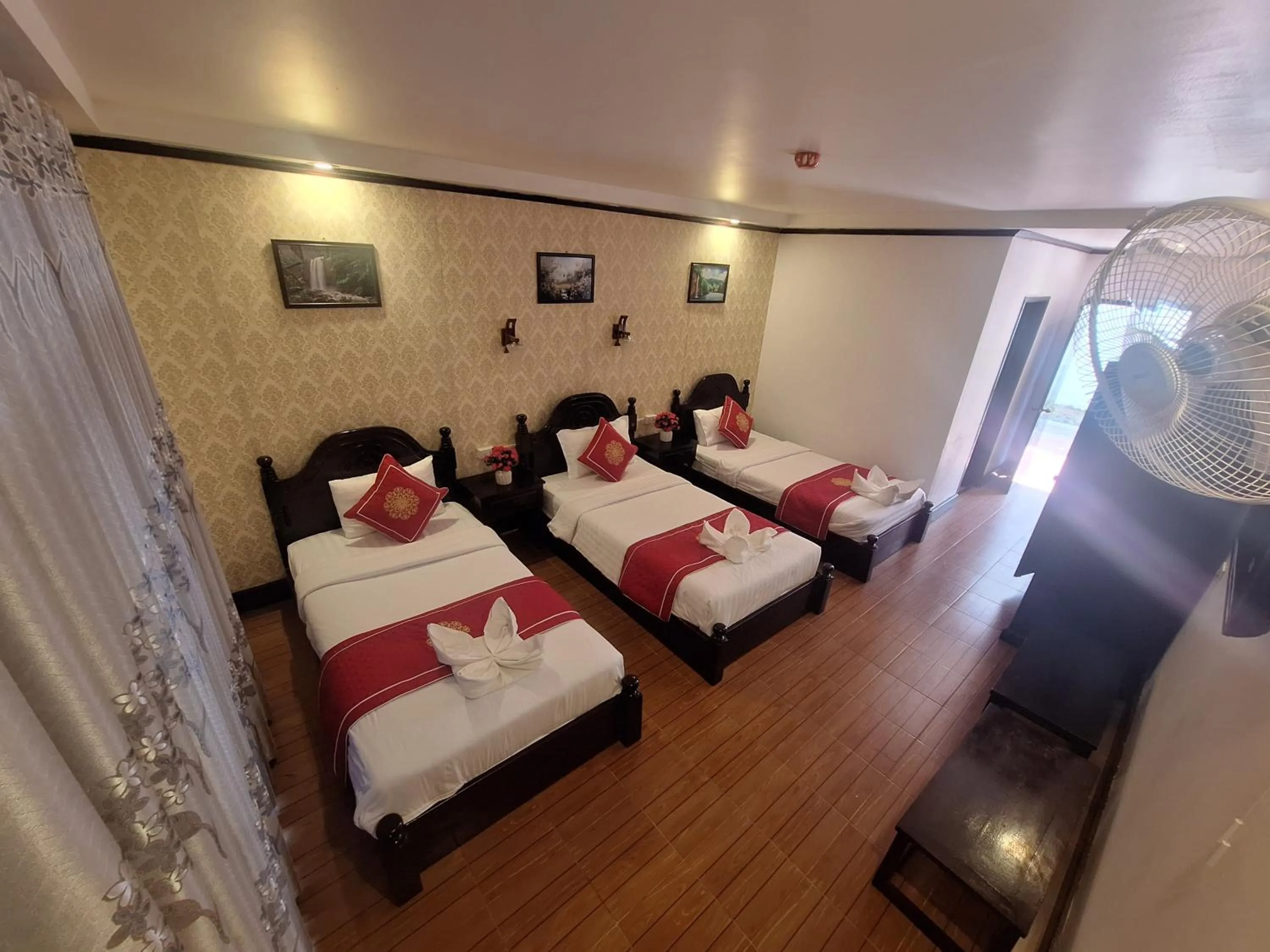 Bed in Luang Prabang Pavilion Hotel & Travel