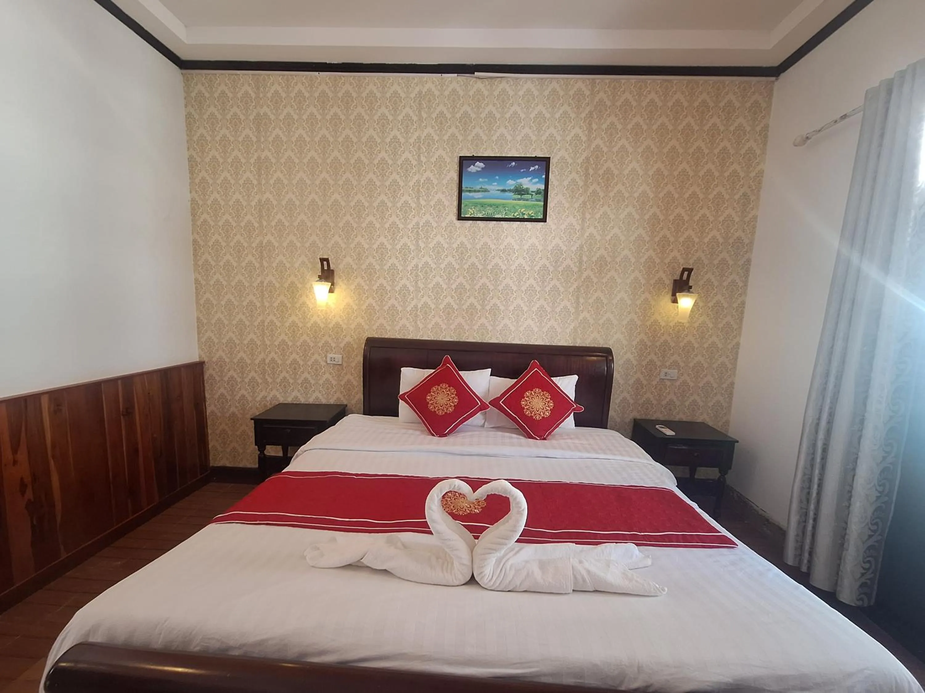 Bed in Luang Prabang Pavilion Hotel & Travel