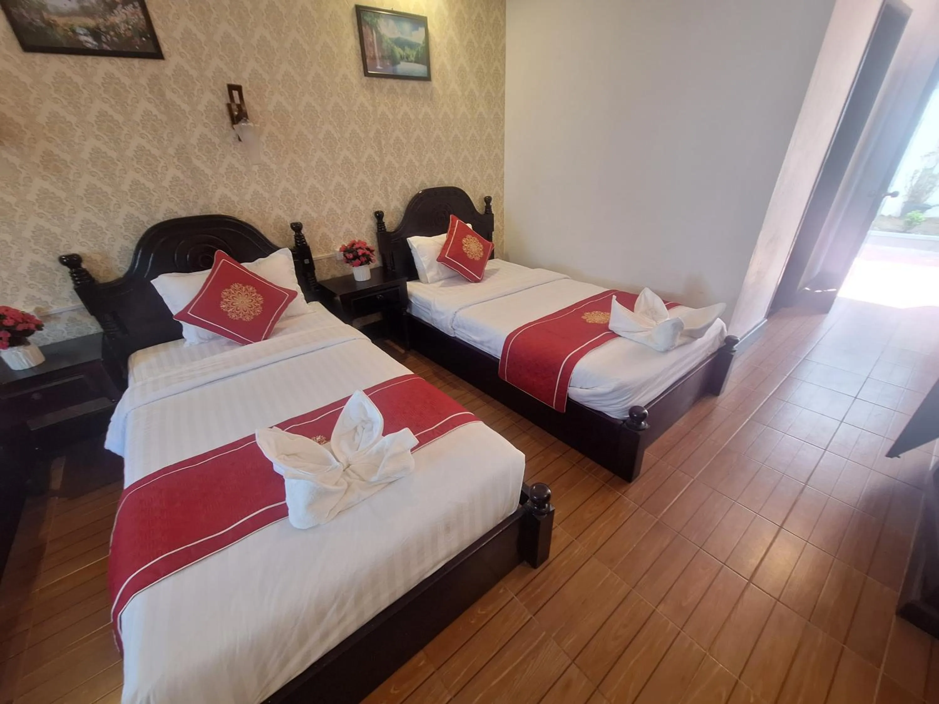 Bed in Luang Prabang Pavilion Hotel & Travel