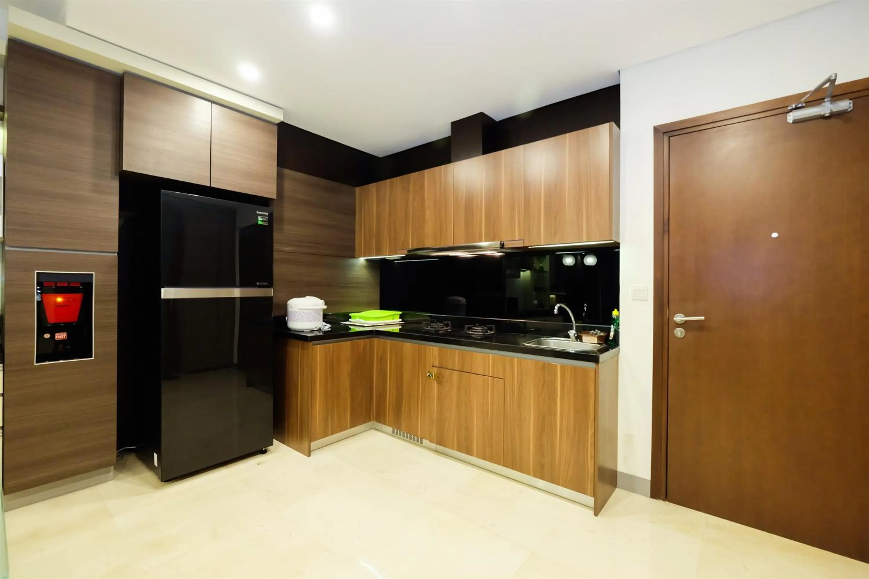 Kitchen or kitchenette in Modern Elegant Design 2BR L'Avenue Apartment By Travelio