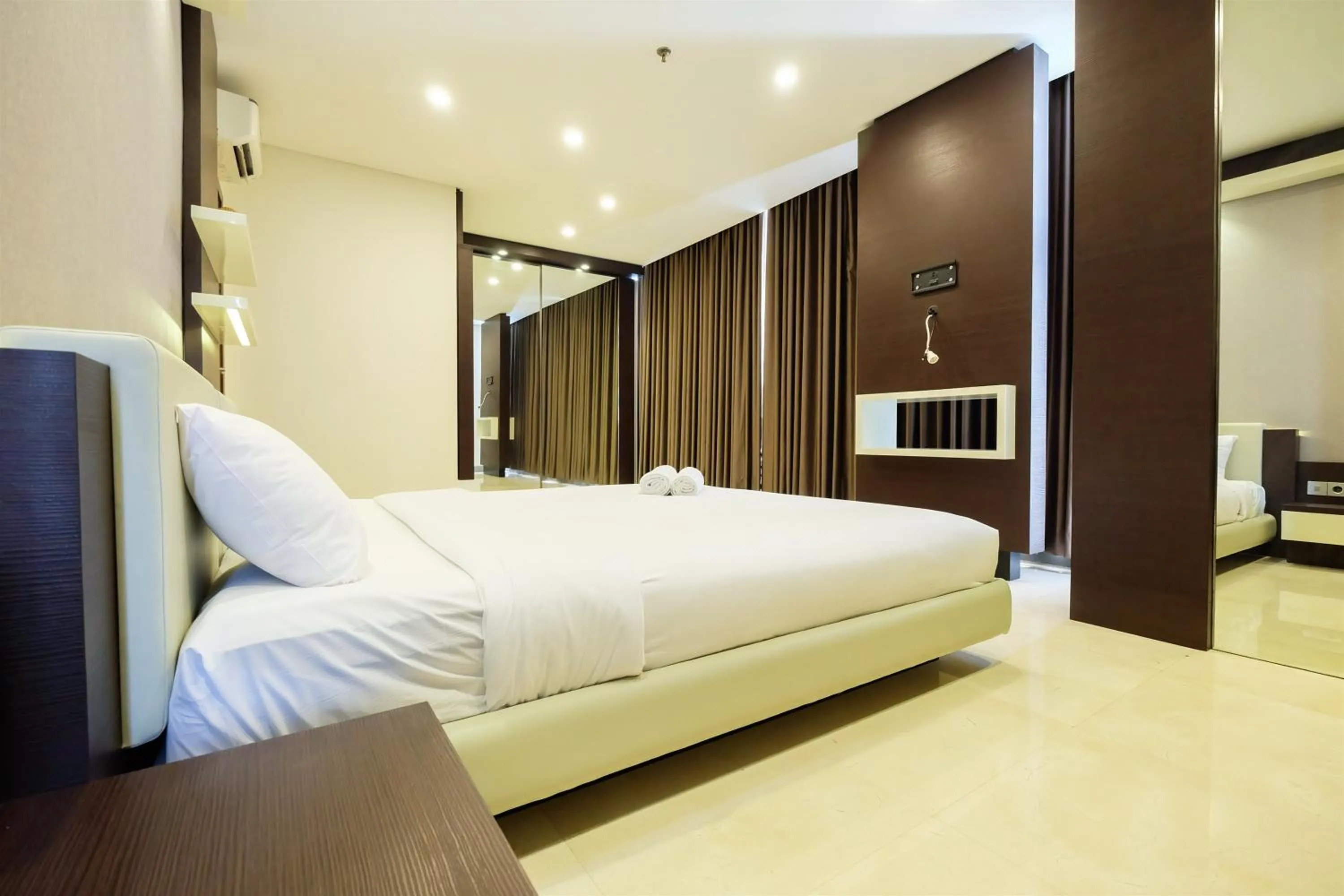 Bed in Modern Elegant Design 2BR L'Avenue Apartment By Travelio