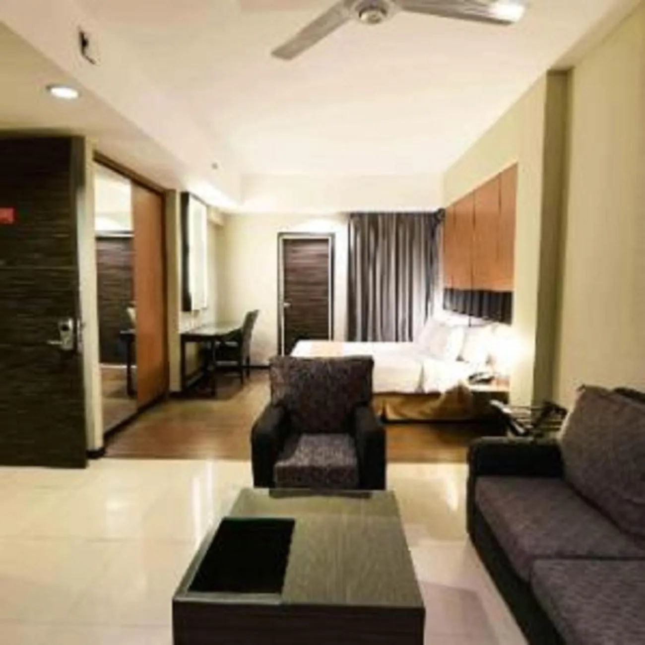 Living room, Bed in The Malibu Suites Balikpapan by Sissae Living
