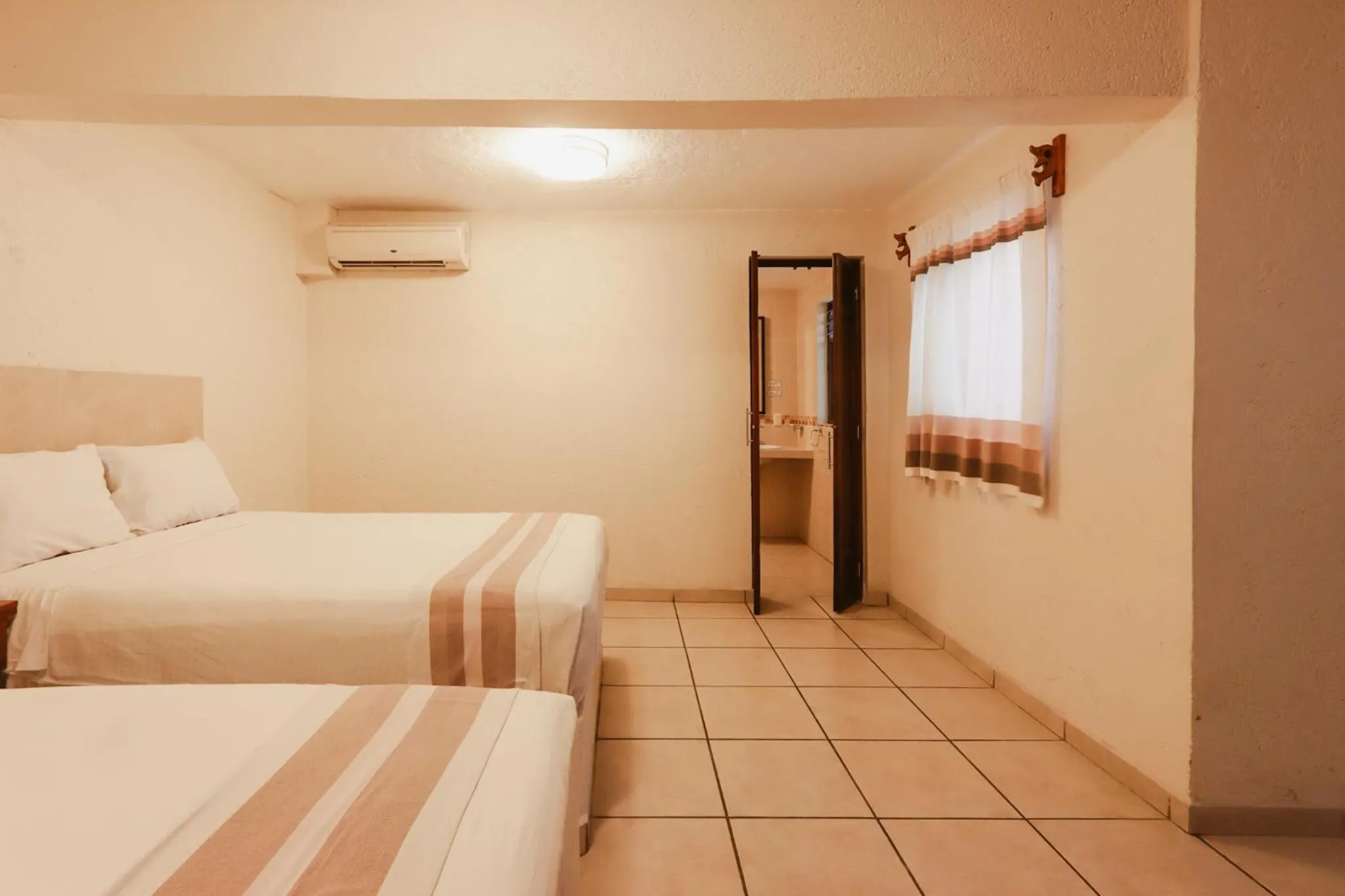 Bed in Hotel Guivá Huatulco