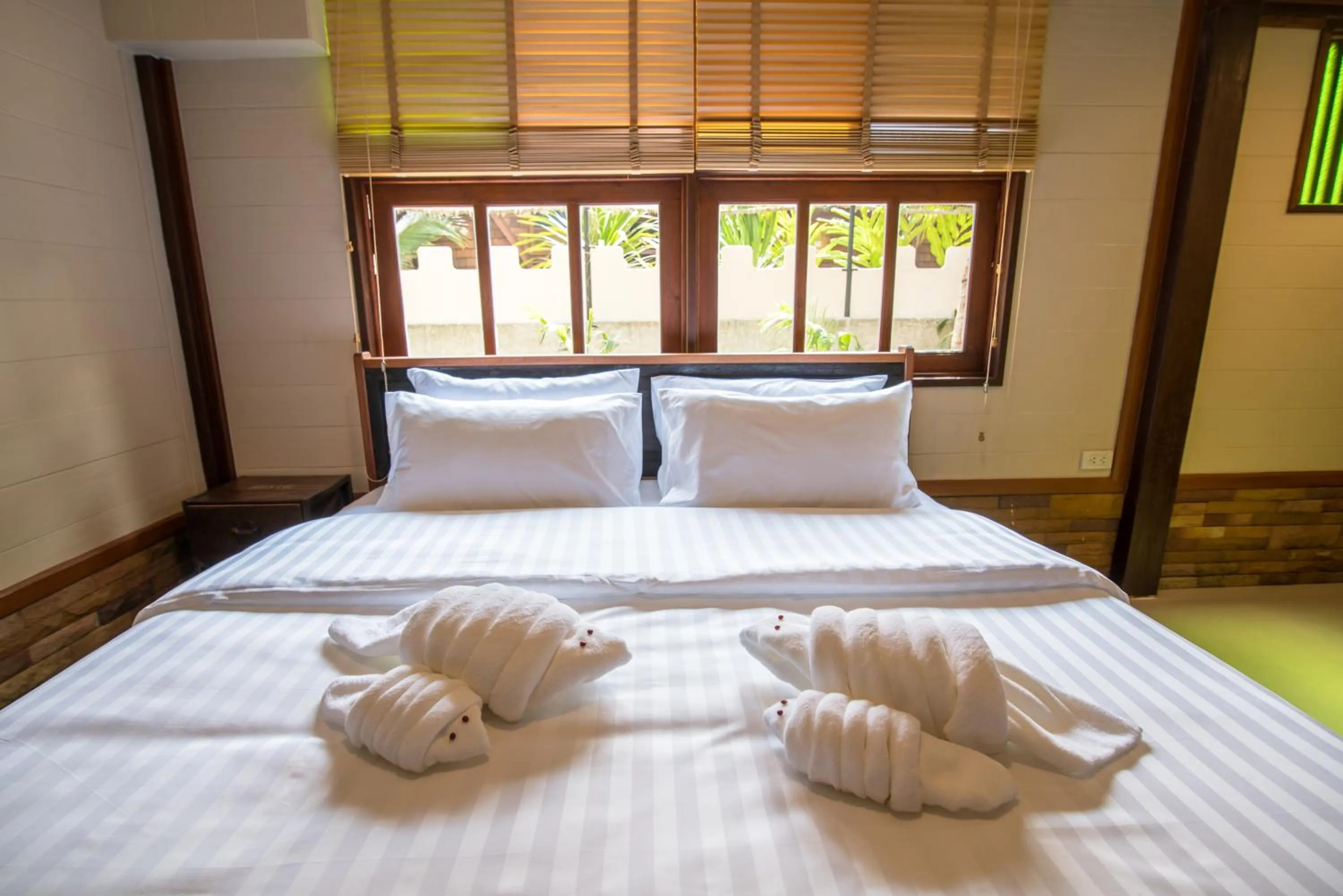 Bed in Suankaew Art Cottage