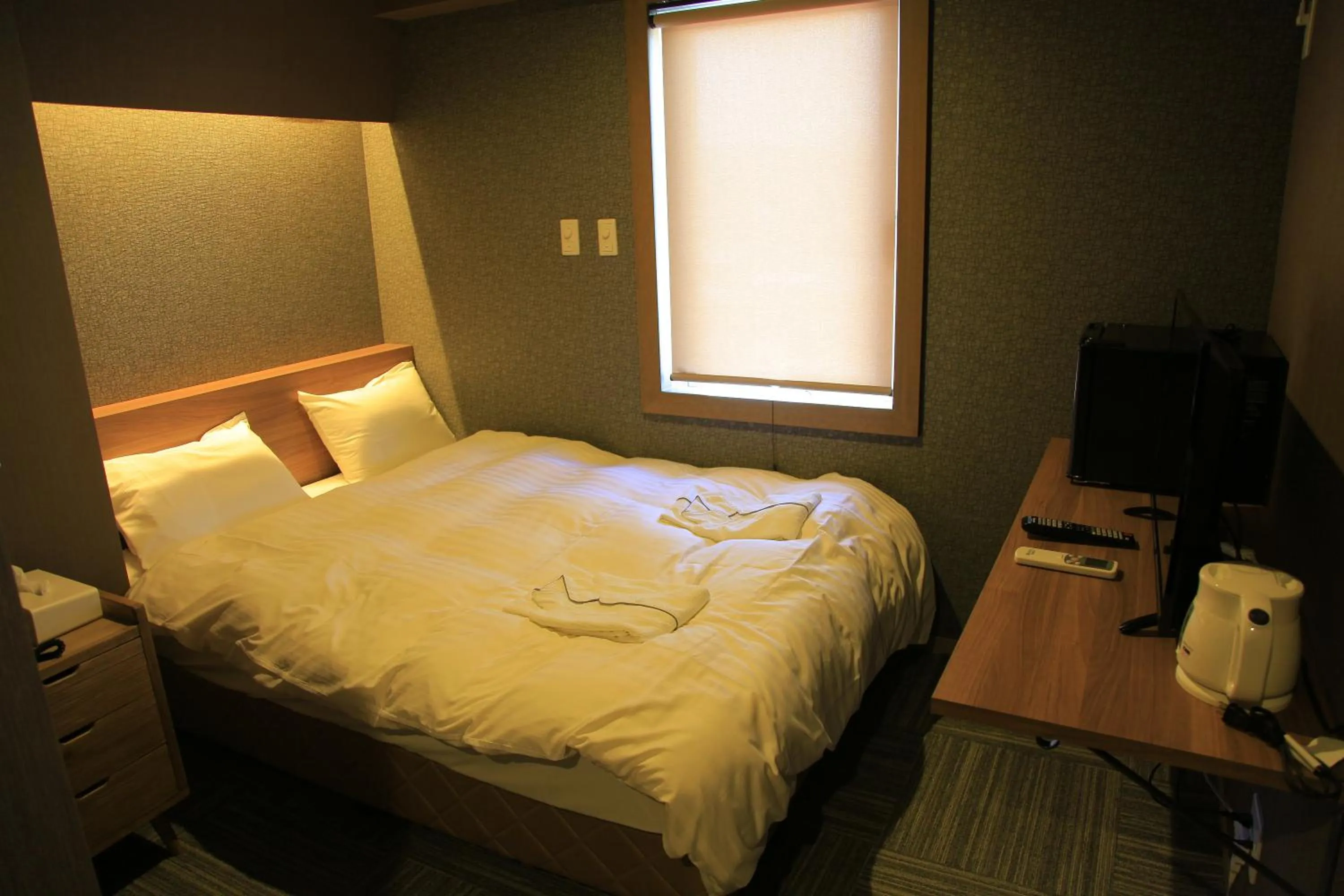 Bed in Ryuka Hotel Naha