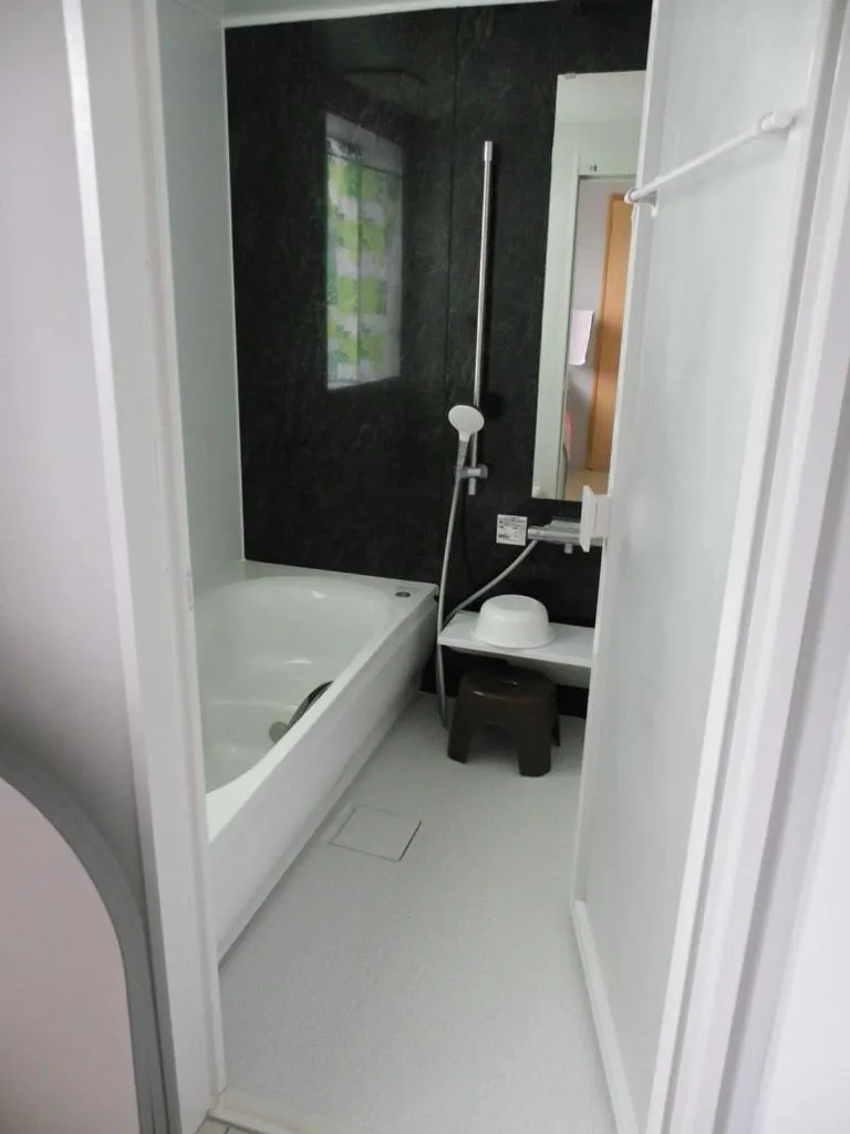 Bathroom, Bed in Guest House Miyakojima