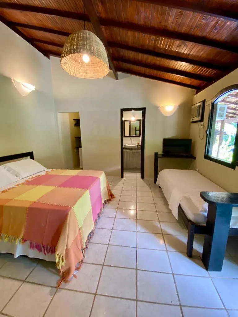 Bed in Pousada Tubarão
