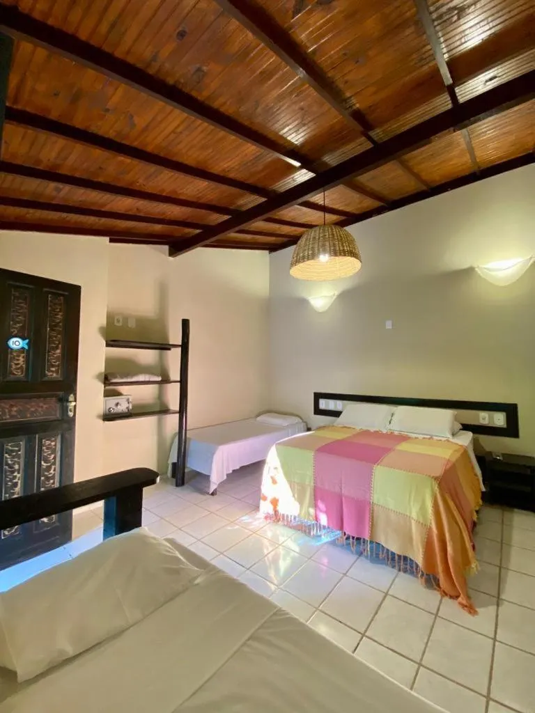 Bed in Pousada Tubarão