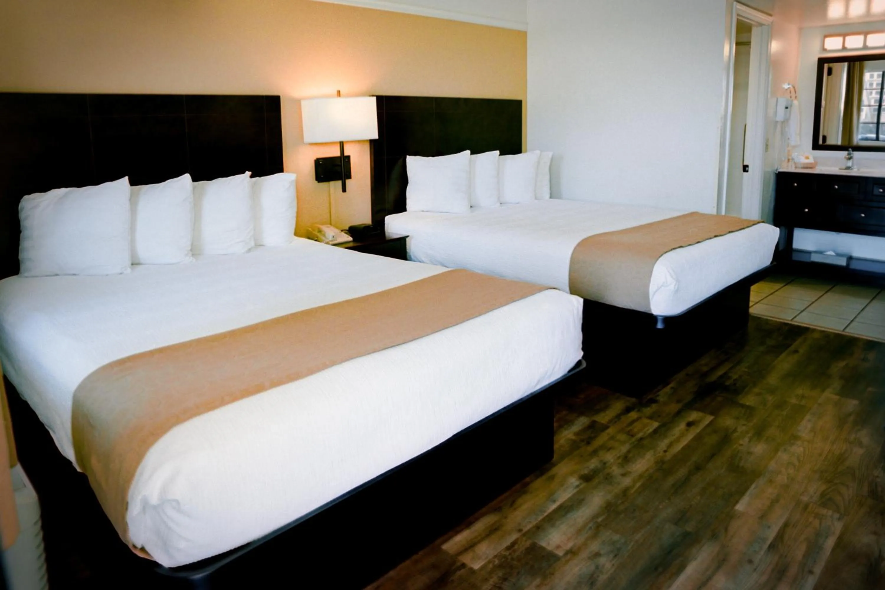 Bed in Pines Inn & Suites