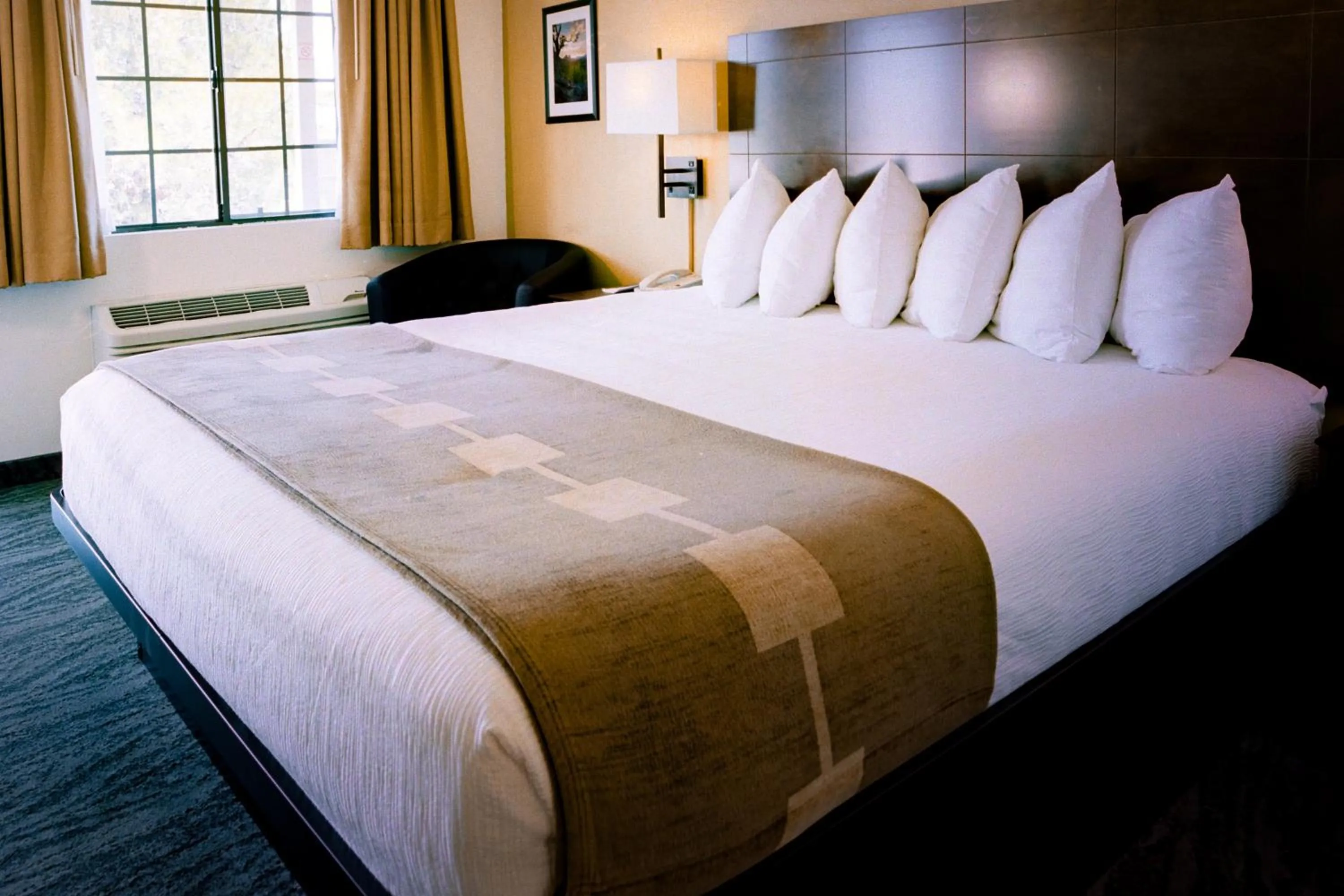 Bed in Pines Inn & Suites