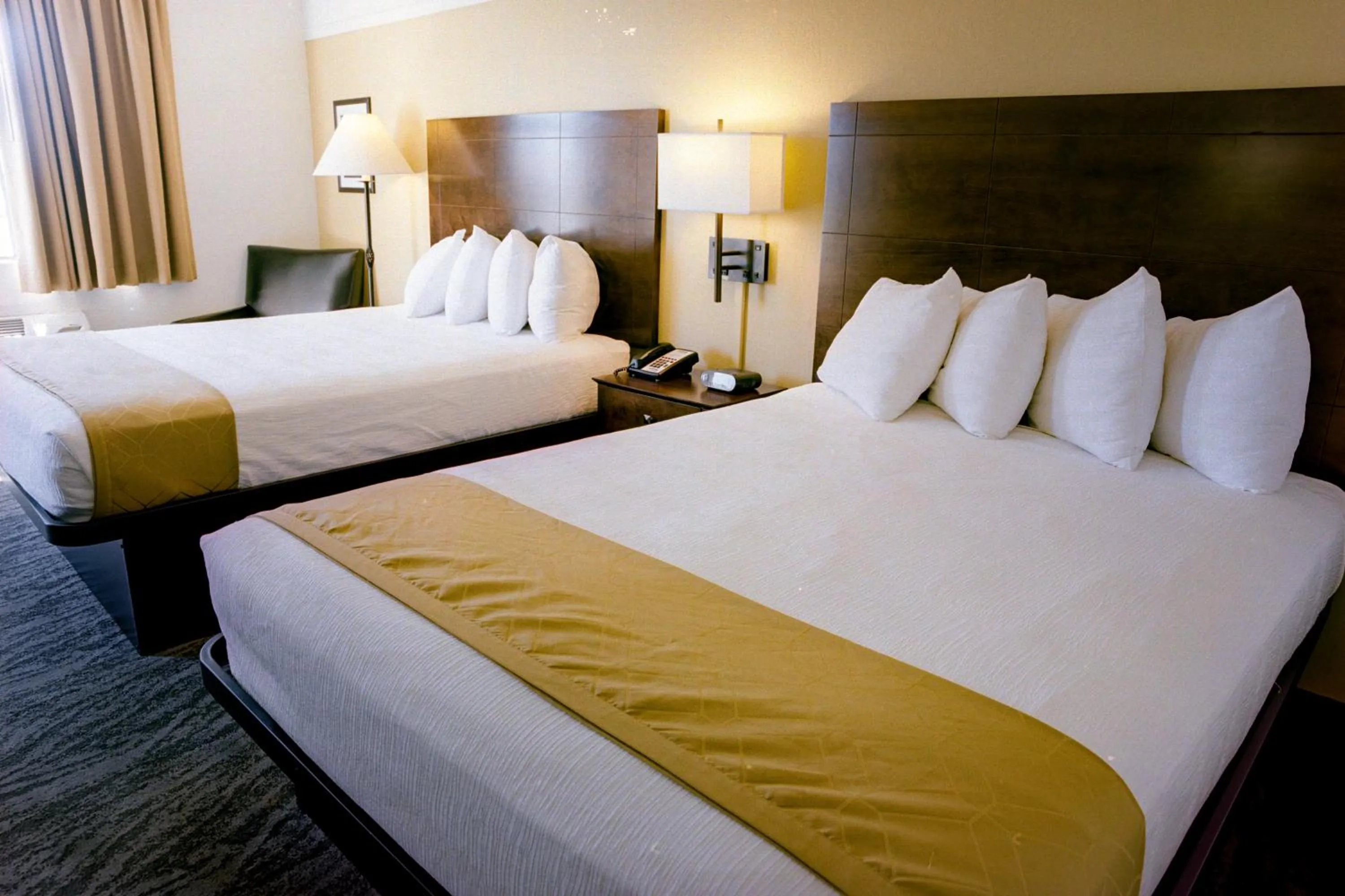 Bed in Pines Inn & Suites