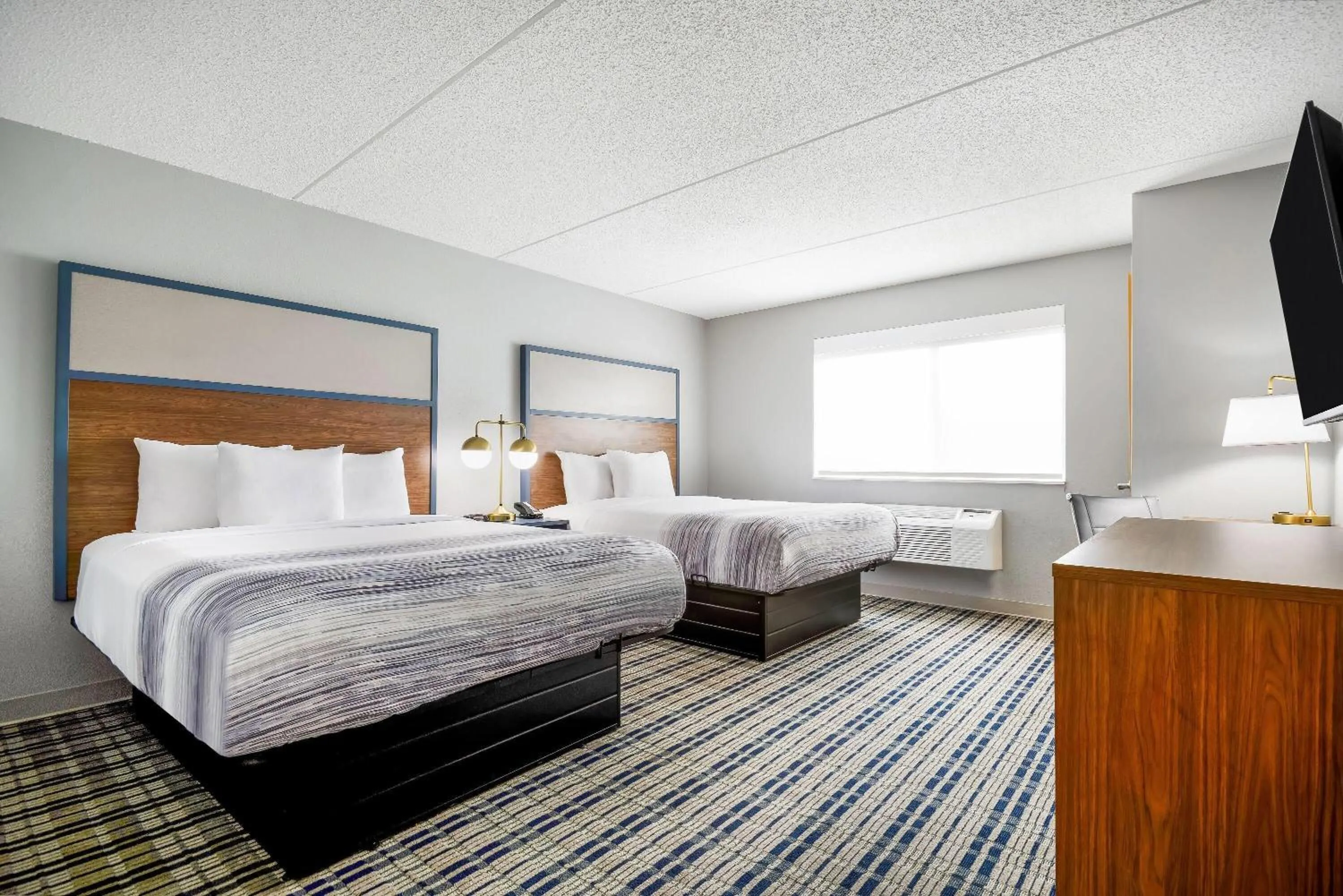 Bed in AmericInn by Wyndham Wausau