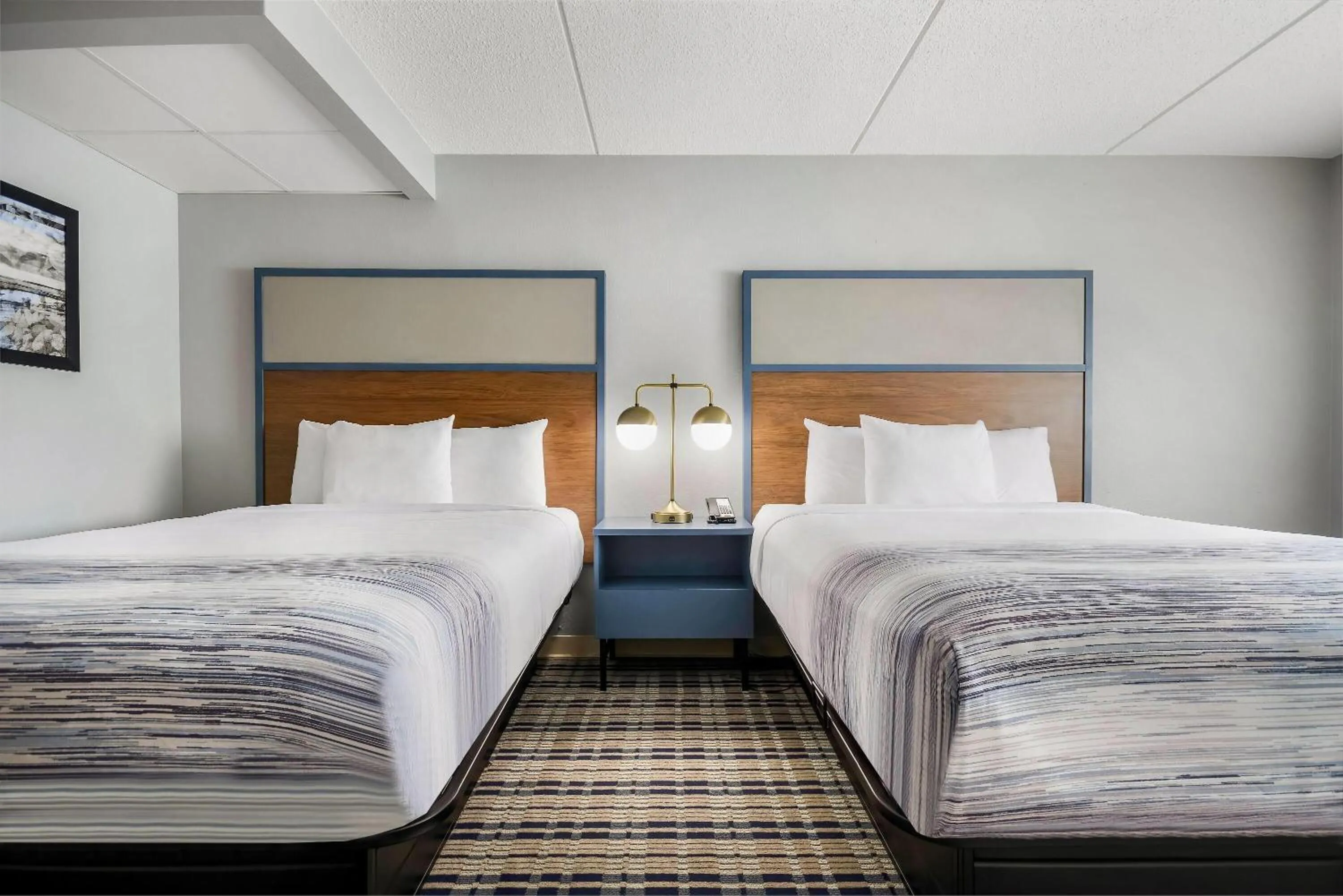 Bed in AmericInn by Wyndham Wausau