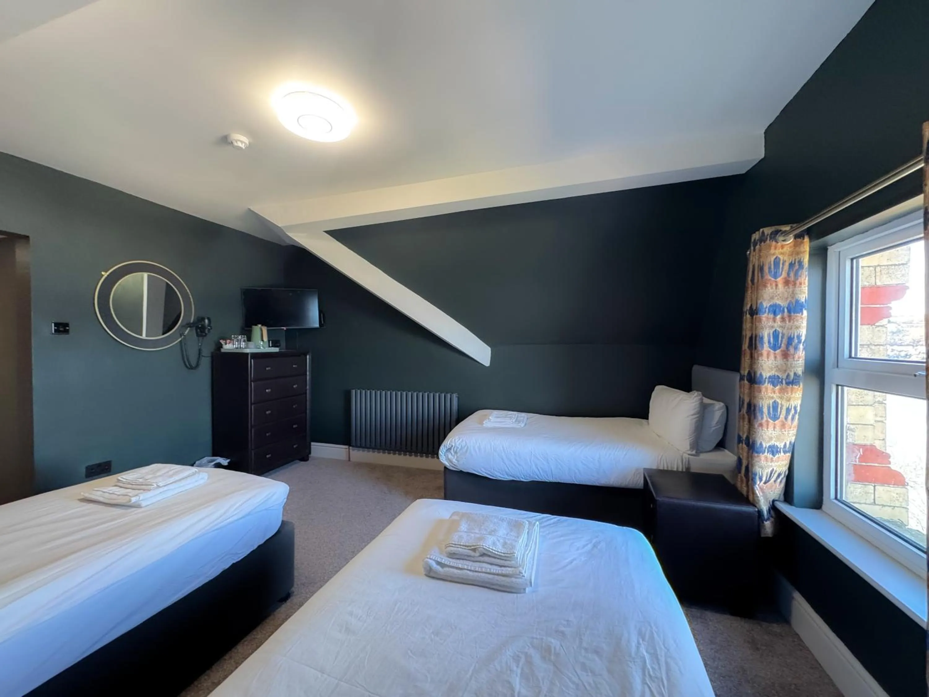 Bed in Nomi Rooms & Restaurant