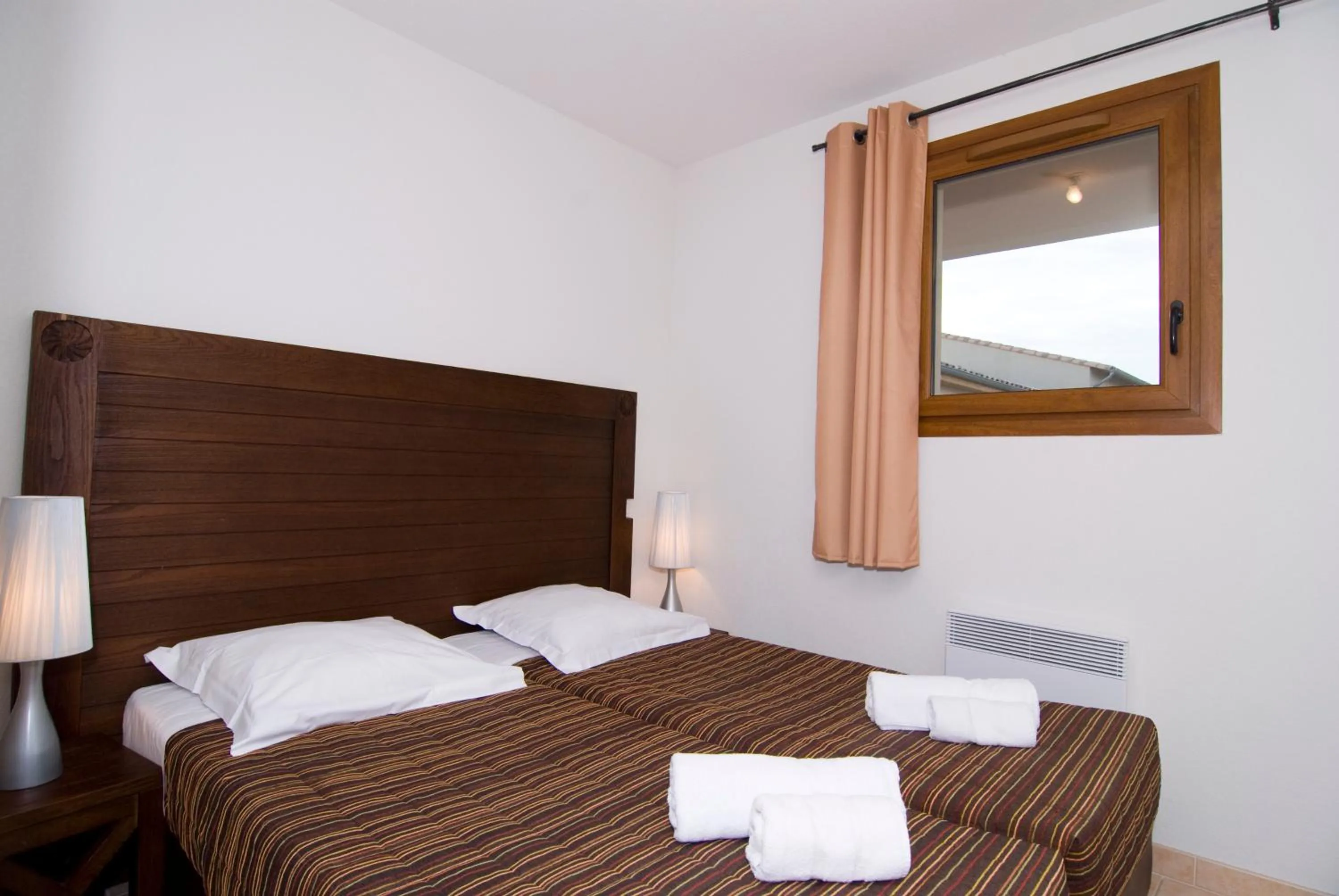 Bedroom in UZES APPART HOTEL Résidence Le Mas des Oliviers