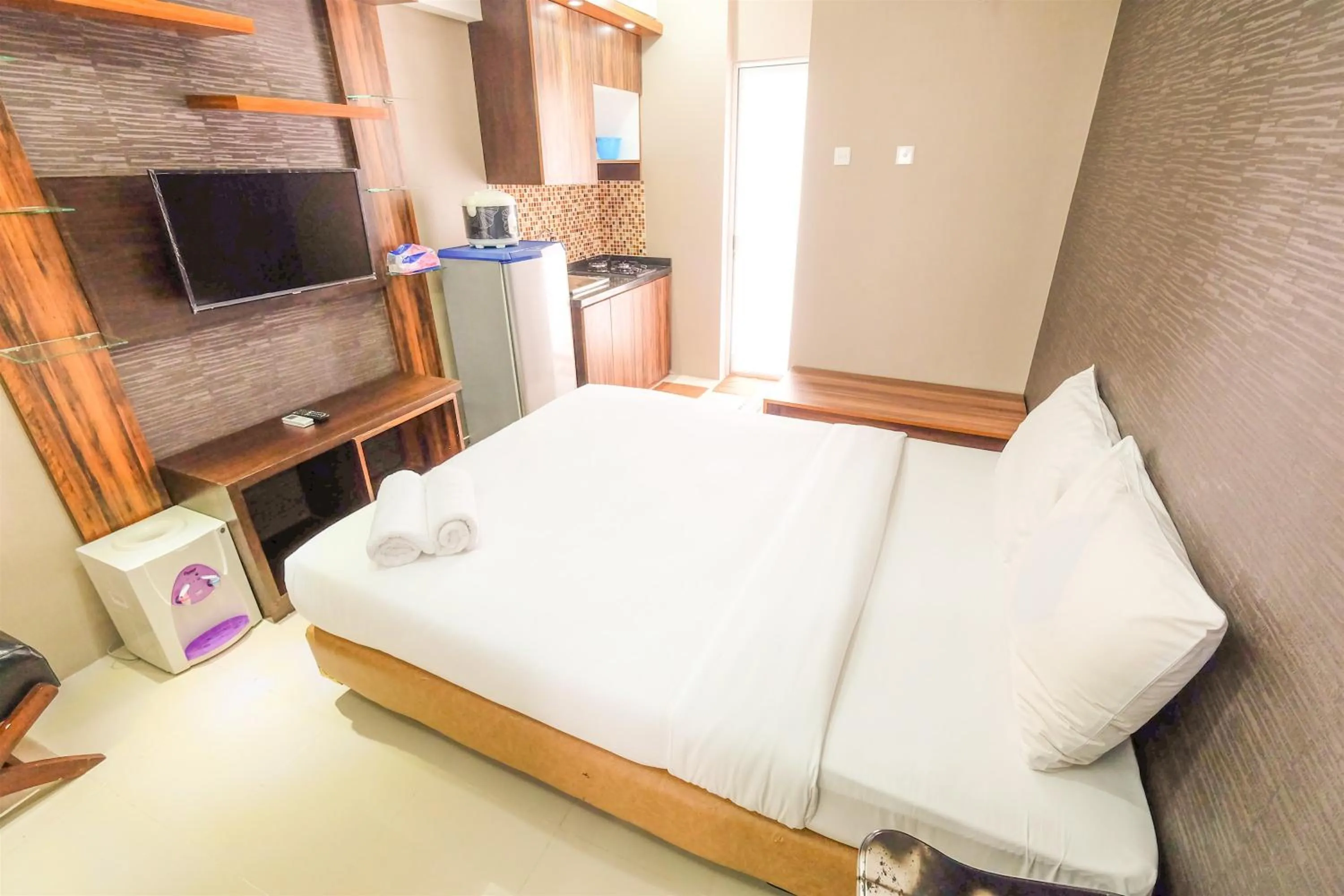 Bed in Simple Studio Bassura City Apartment By Travelio