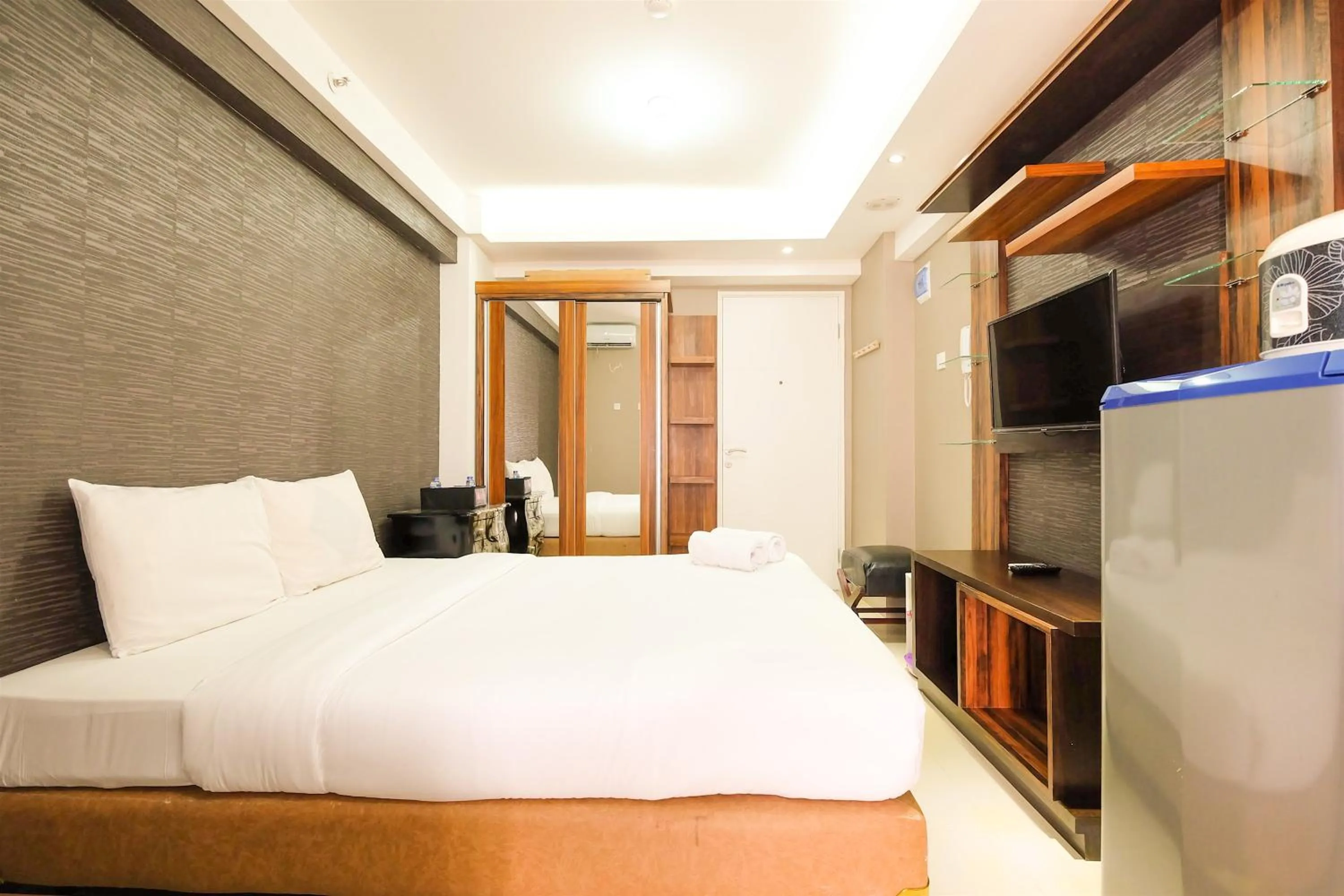 Bed in Simple Studio Bassura City Apartment By Travelio
