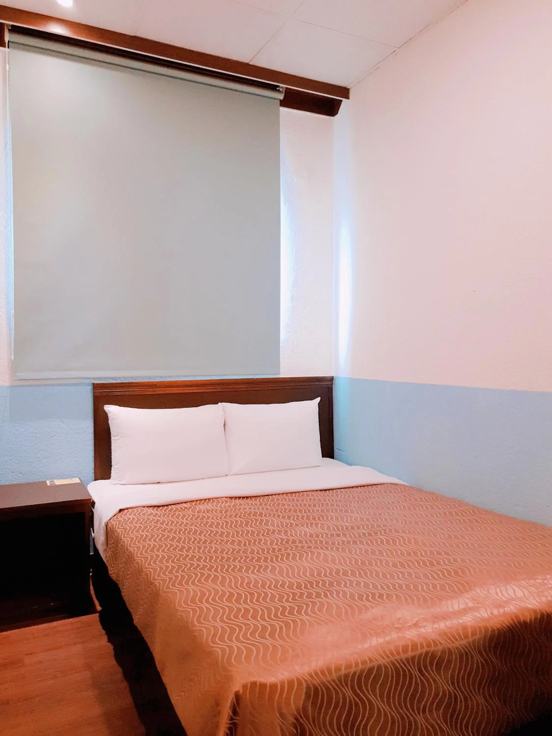 Bed in Blue Ocean Hotel