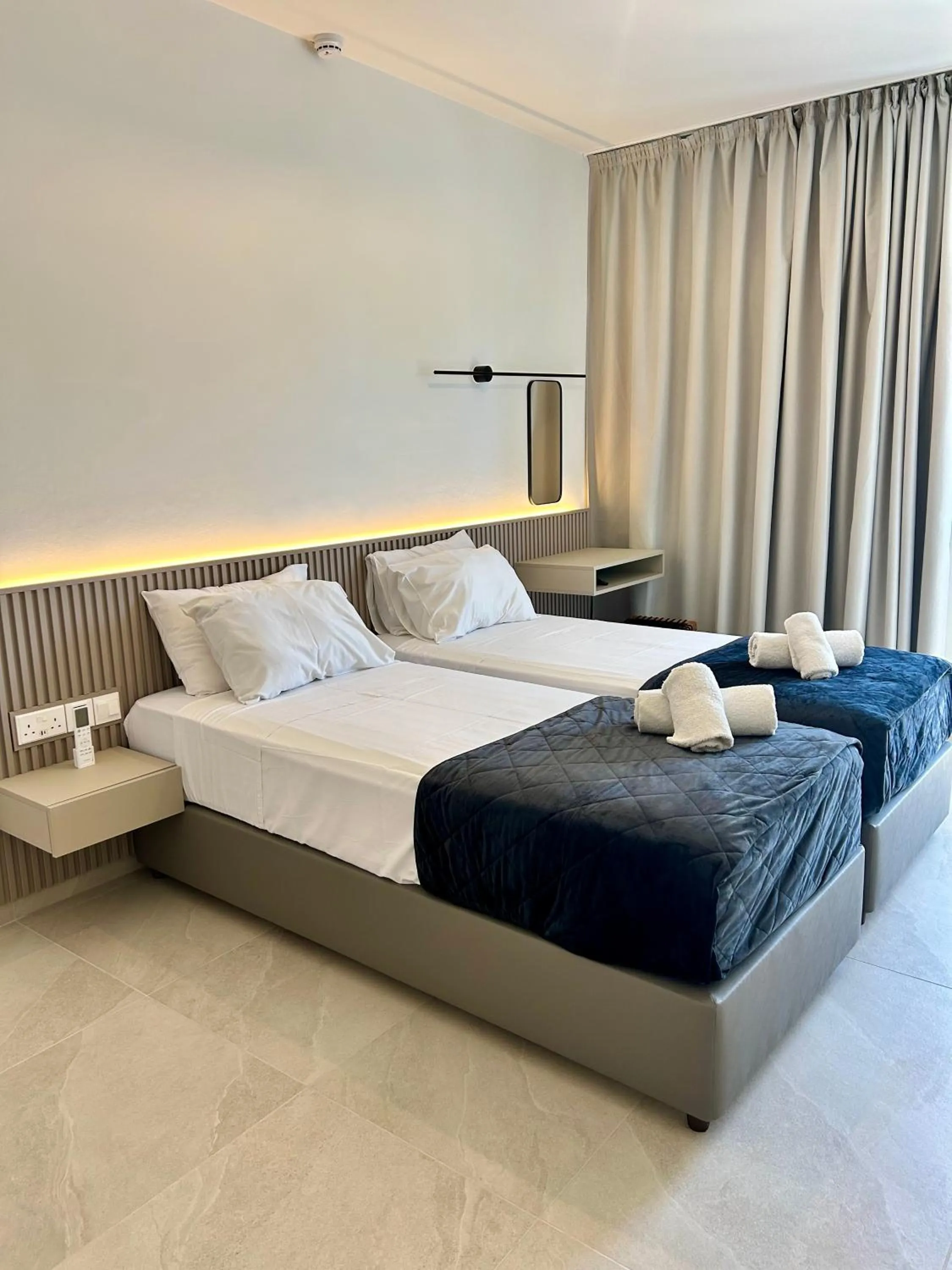 Bed in Pigeon Beach Hotel Apartments