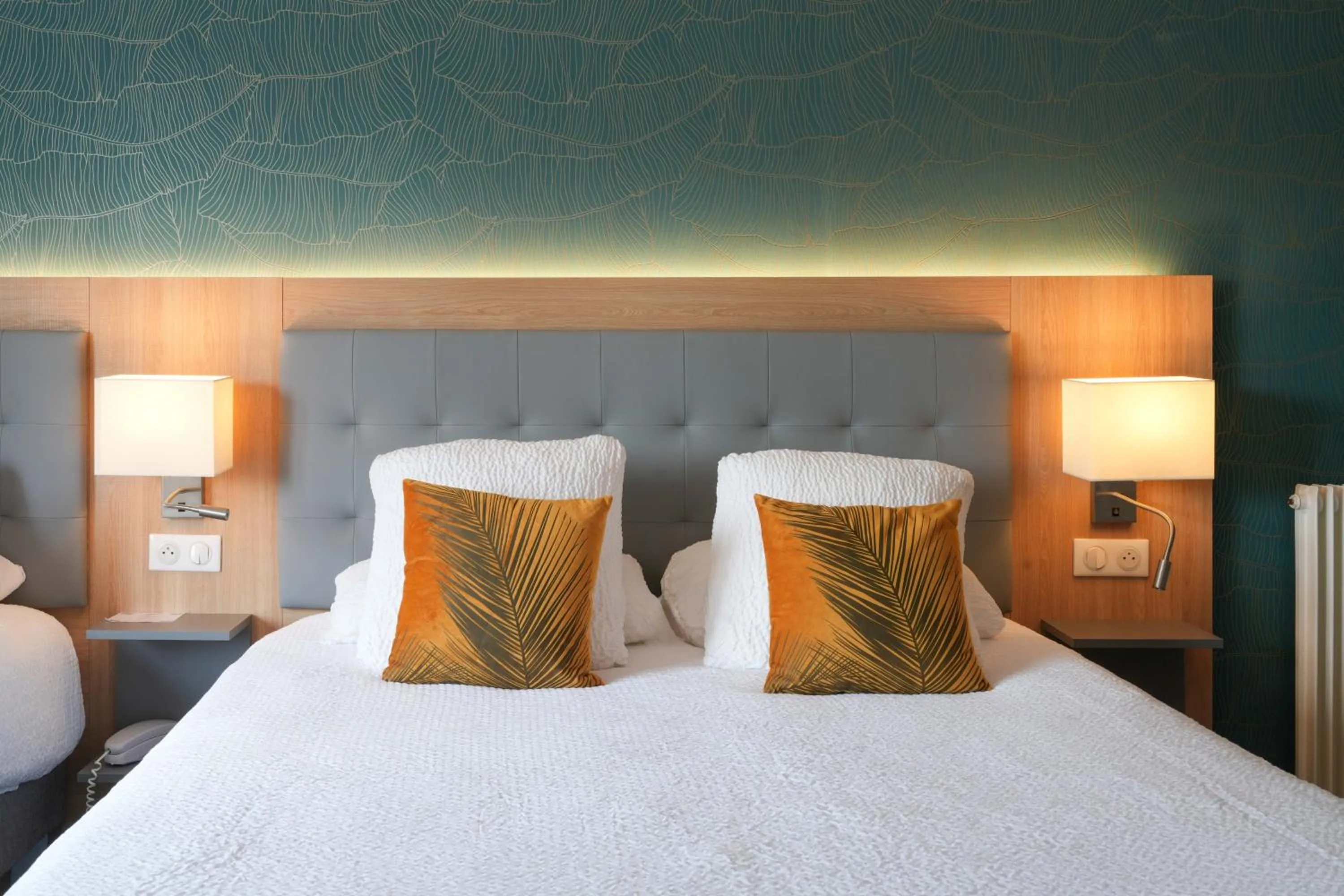 Bed in Logis Hôtel l'Amandier