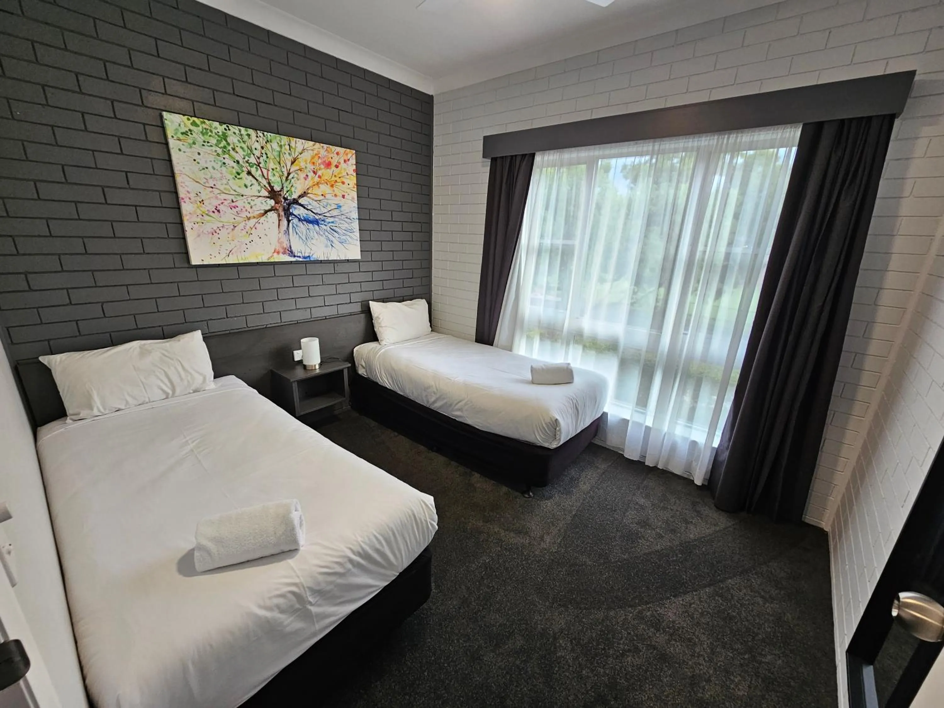 Bed in Blue Violet Motor Inn