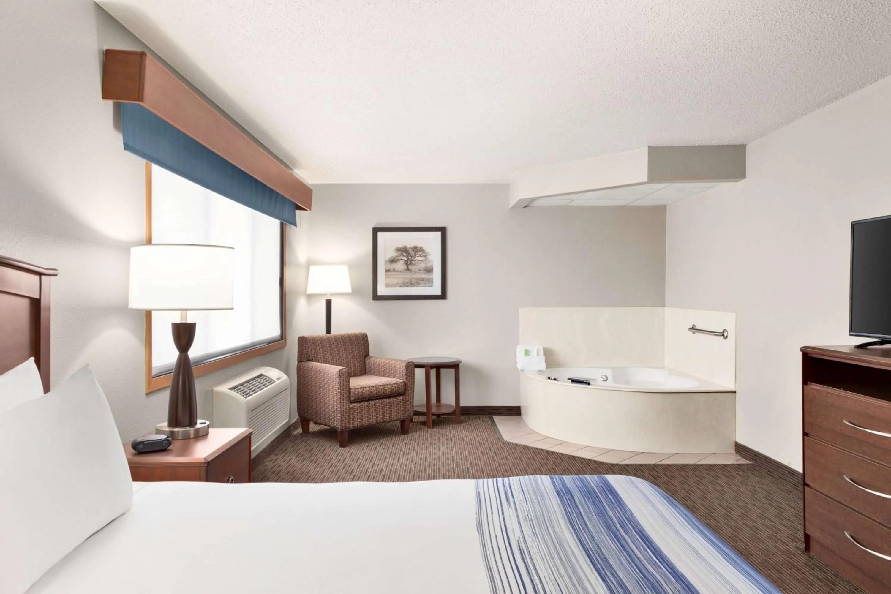 Bed in AmericInn by Wyndham Sauk Centre