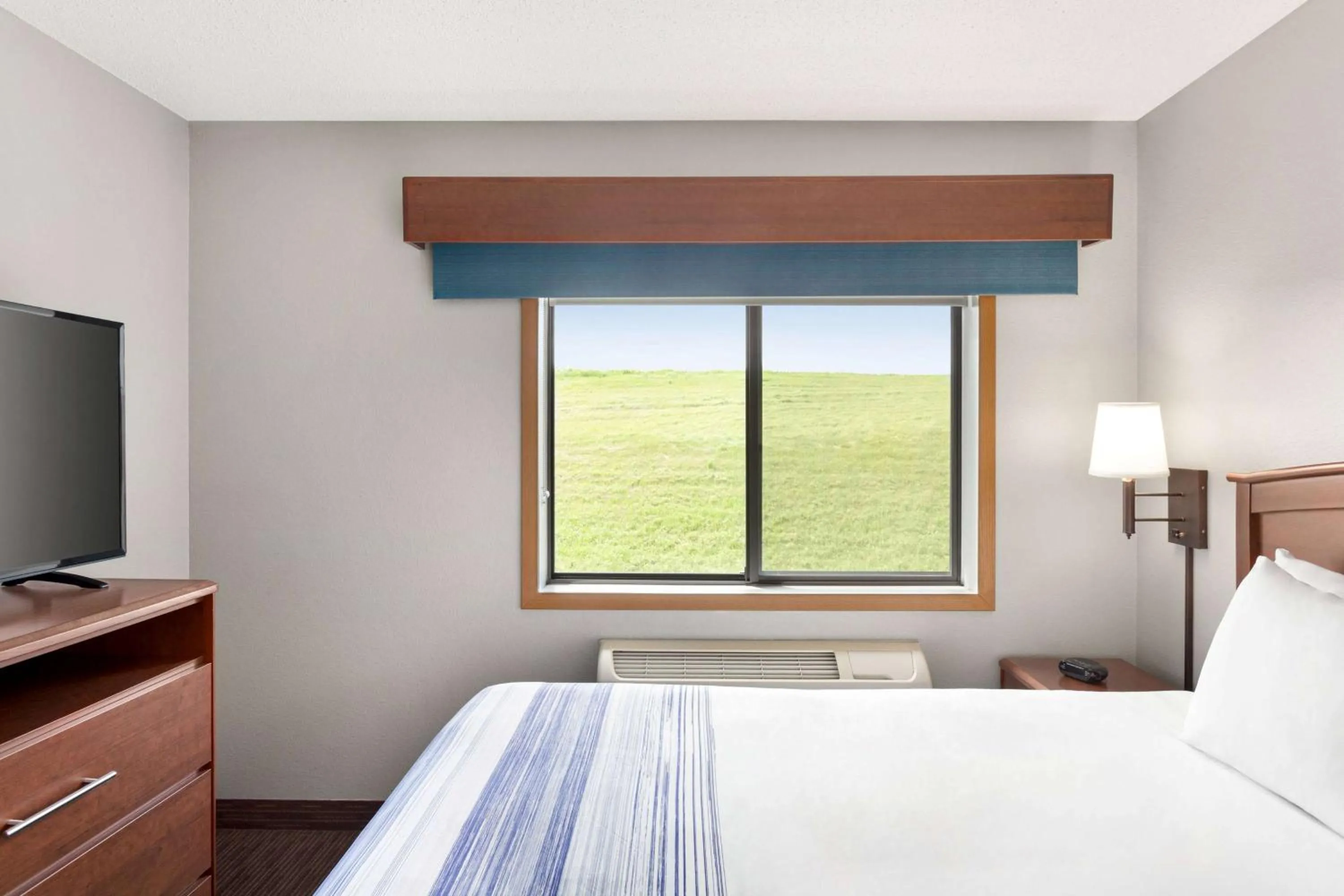 Bed in AmericInn by Wyndham Sauk Centre