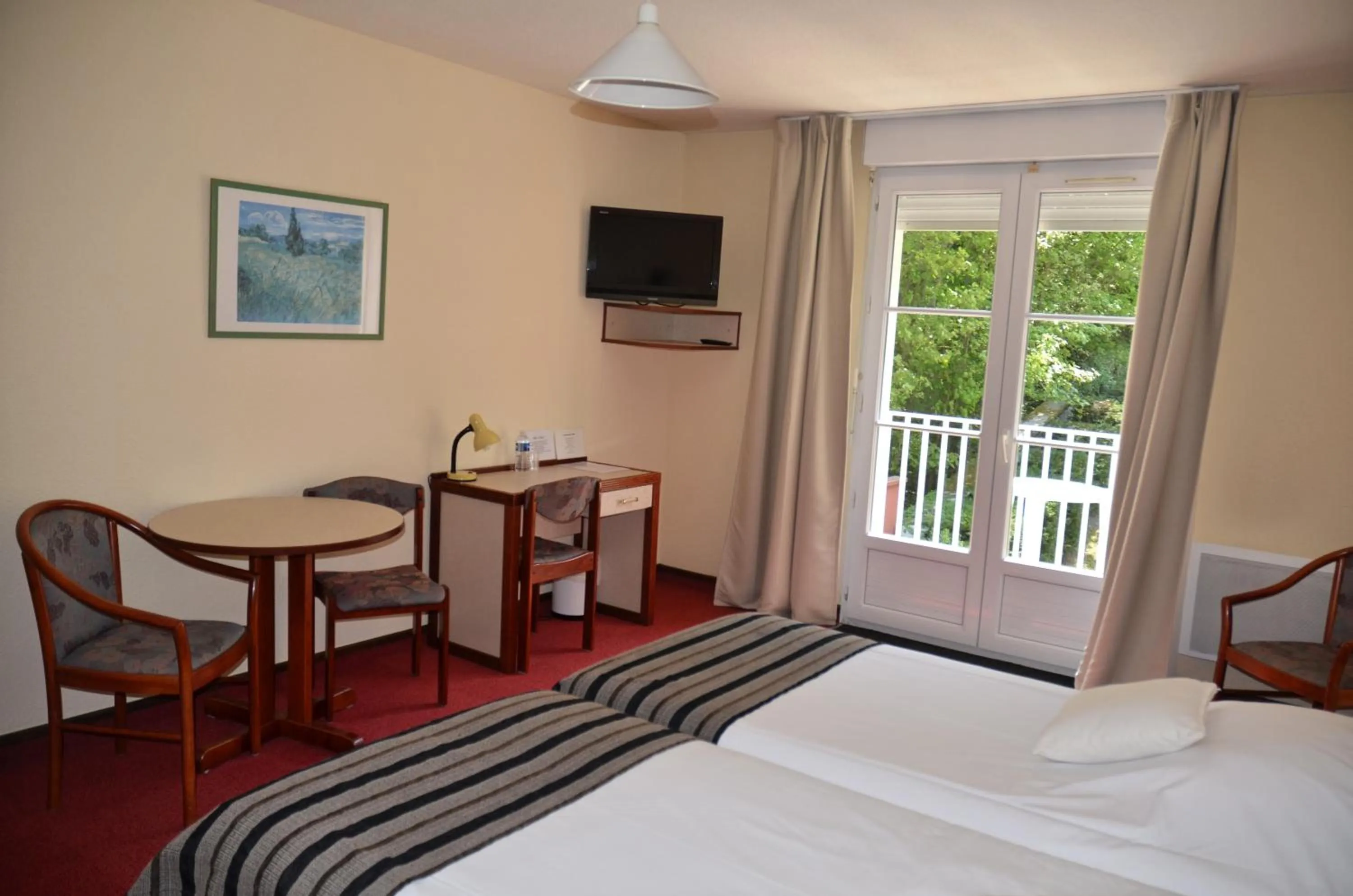 Bed in Hôtel et Studios d'Orfeuil