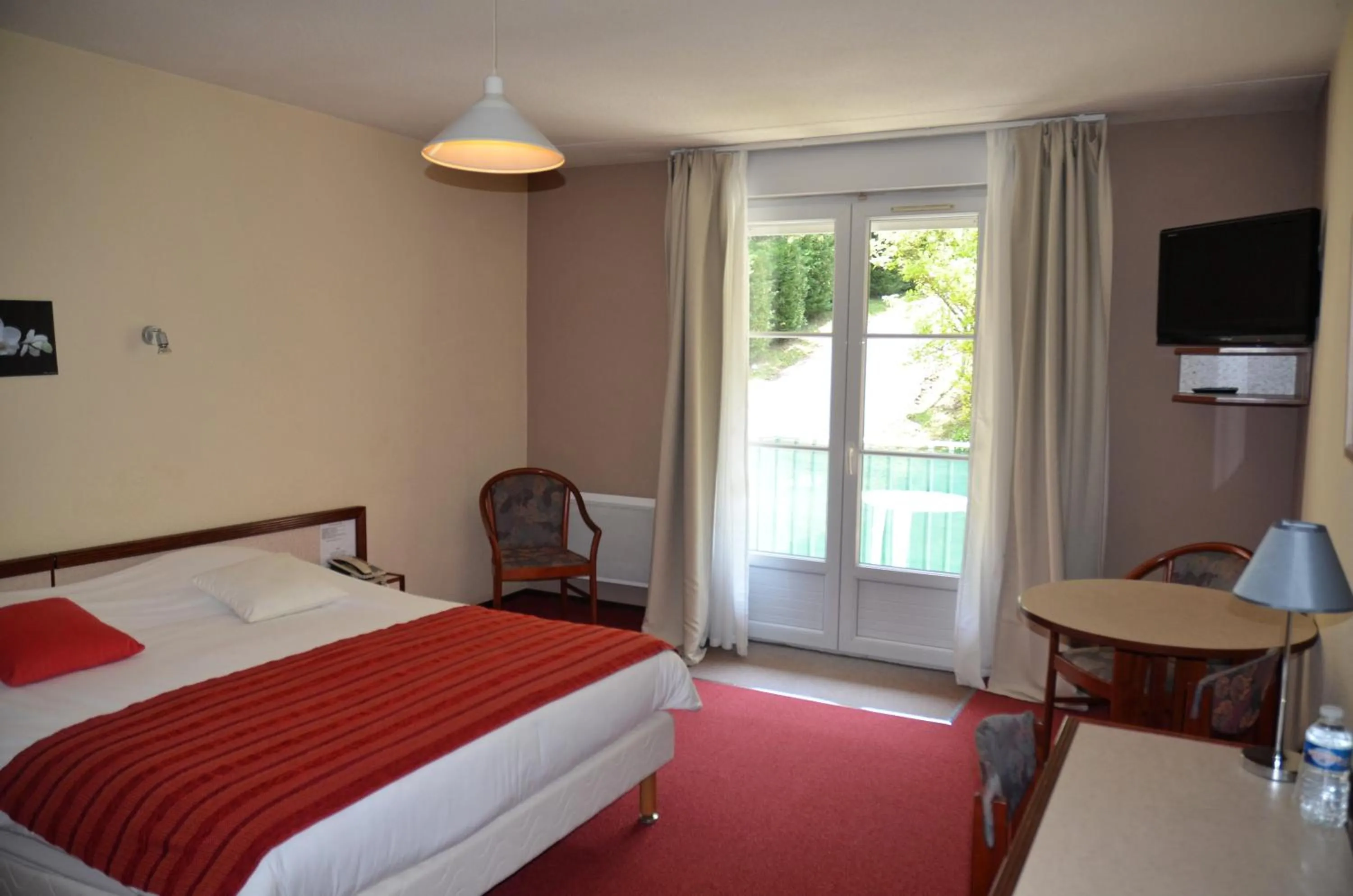 Bed in Hôtel et Studios d'Orfeuil