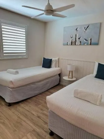 Bed in Grand Palais Boolarong Beachside Apartments