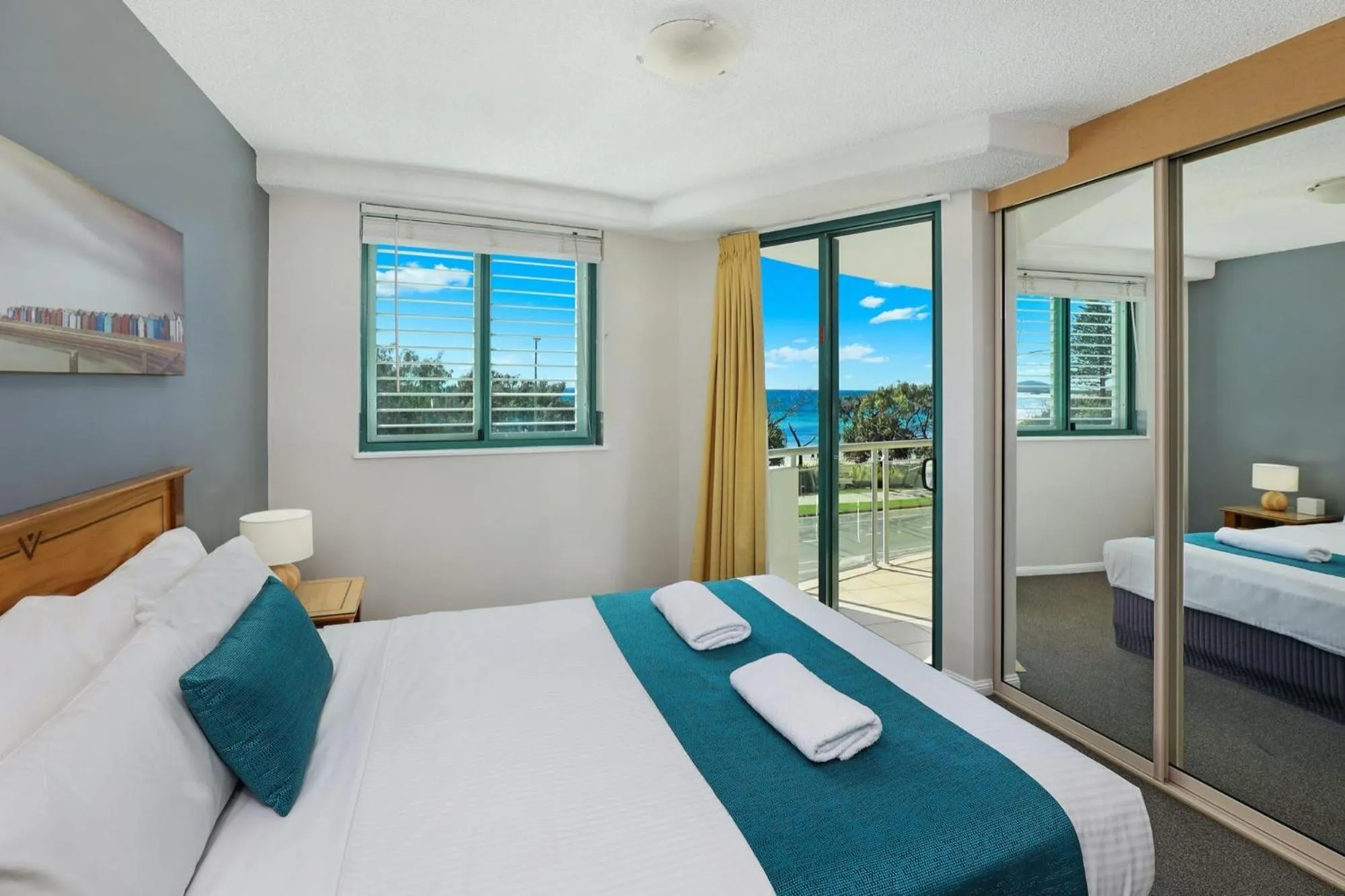 Bed in Grand Palais Boolarong Beachside Apartments