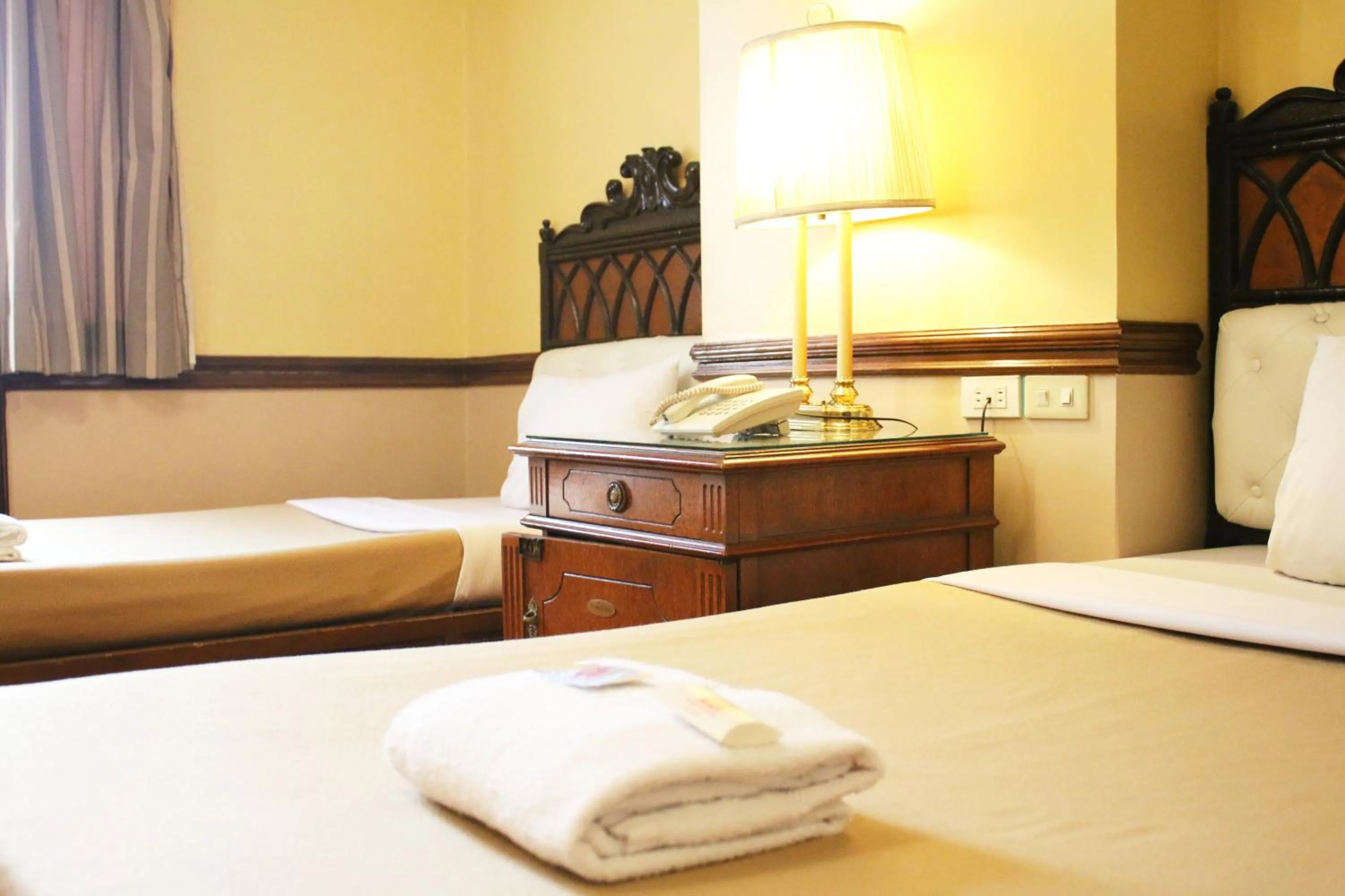 Bed in Camelot Hotel Quezon City powered by Cocotel