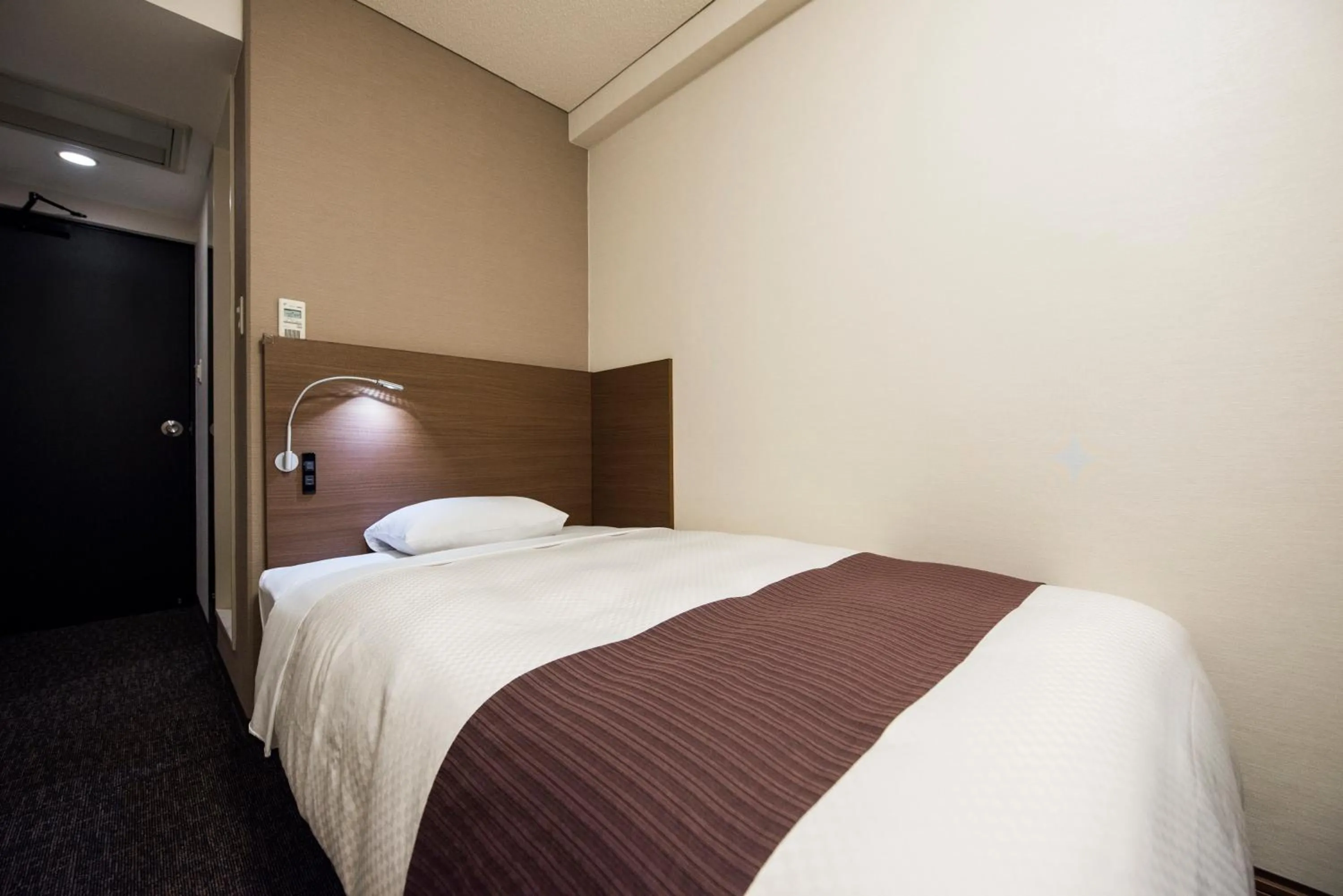 Photo of the whole room, Bed in Nagasaki Bus Terminal Hotel