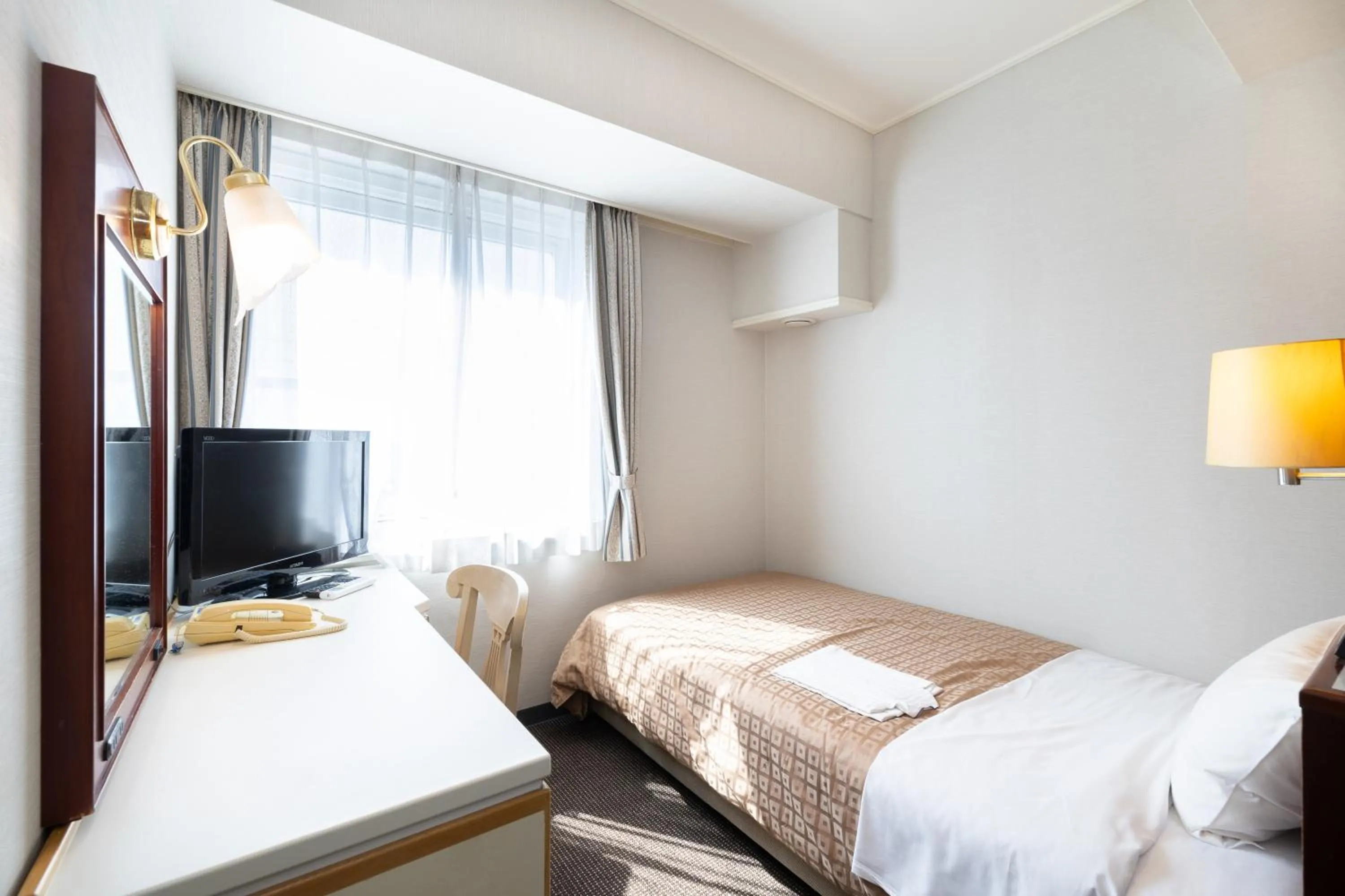 Bed in Hiroshima Intelligent Hotel Annex