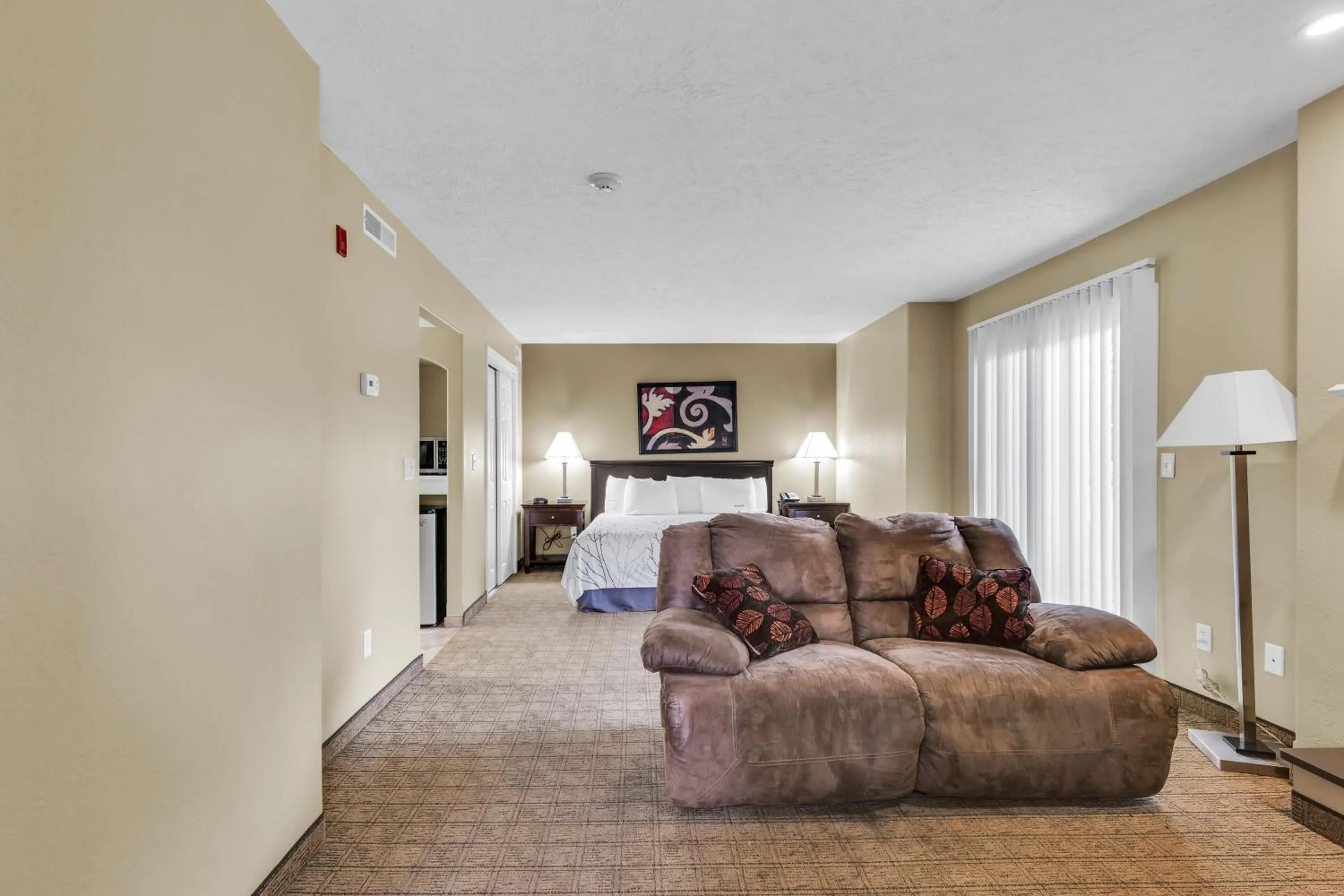 Seating area, Bed in Eastlake Suites Hotel & Conference Center By OYO Urbana